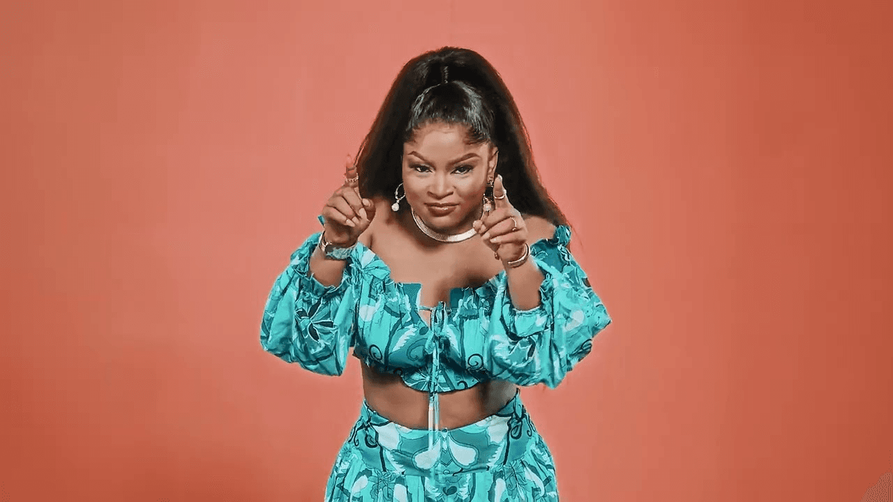 Man sitting against blue wall.