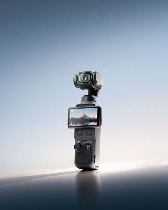 A compact camera with a gimbal and display screen showcasing a landscape image, set against a smooth gradient background.