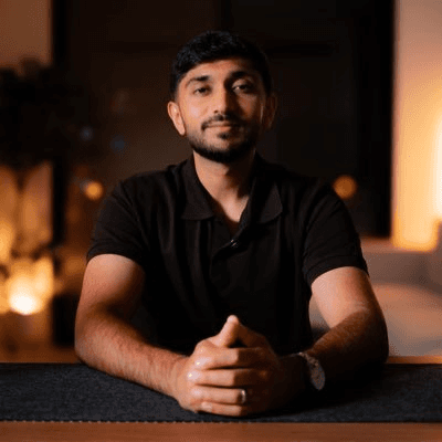 A person wearing a green frog costume