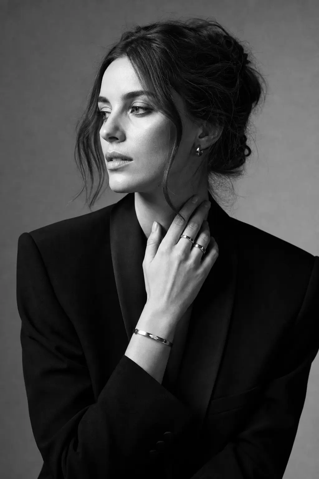 AI-generated black and white fashion portrait of a woman in a structured blazer with timeless editorial styling.
