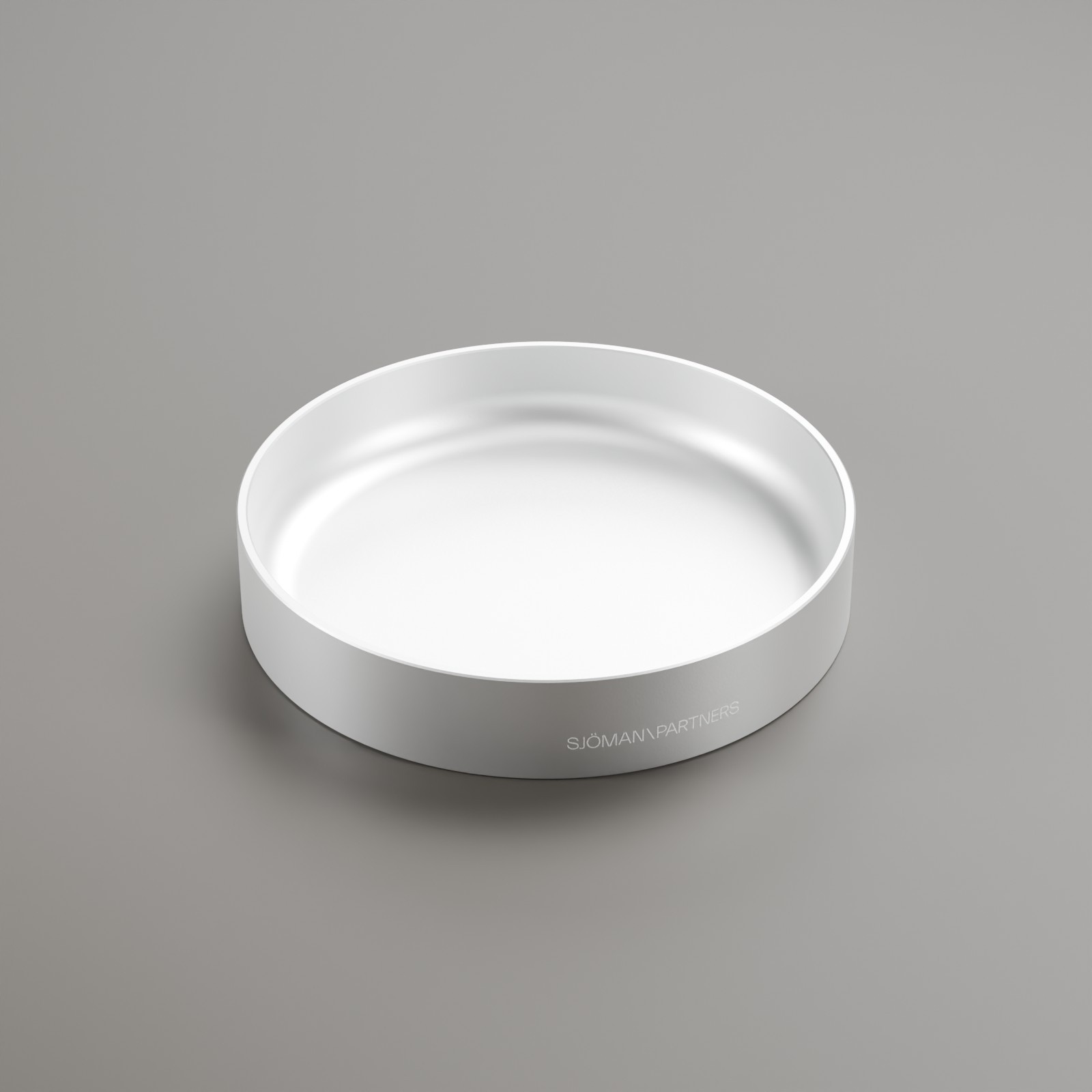 Circular metal tray with a matte blasted finish