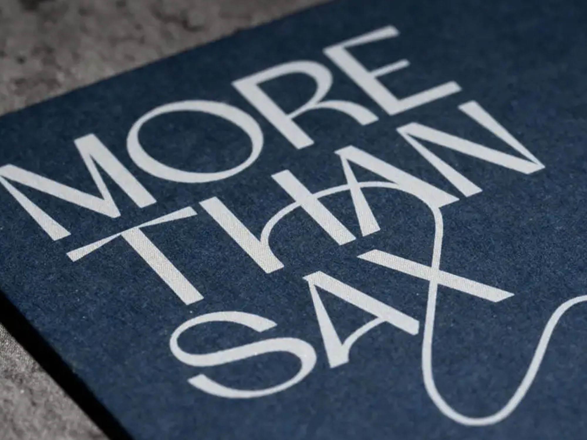 Close up of a business card with white text and a blue background