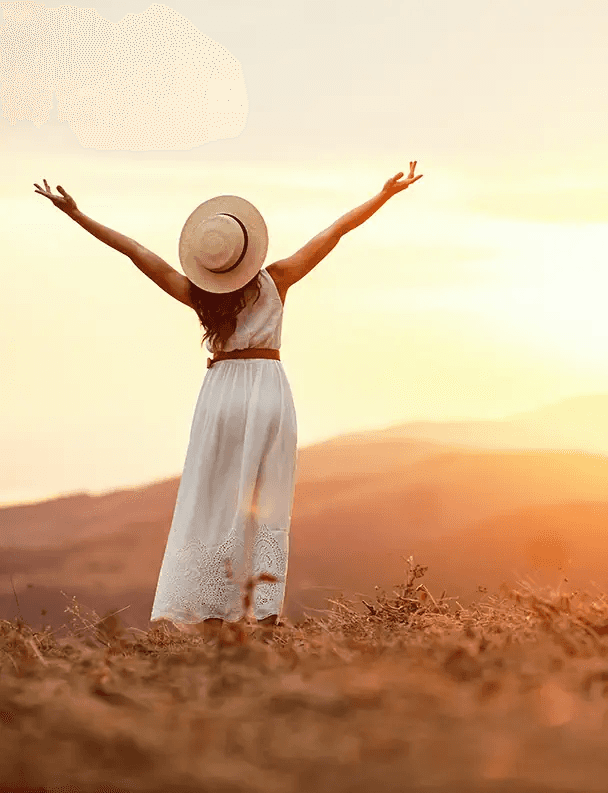 Woman celebrating at sunset, representing a fresh start