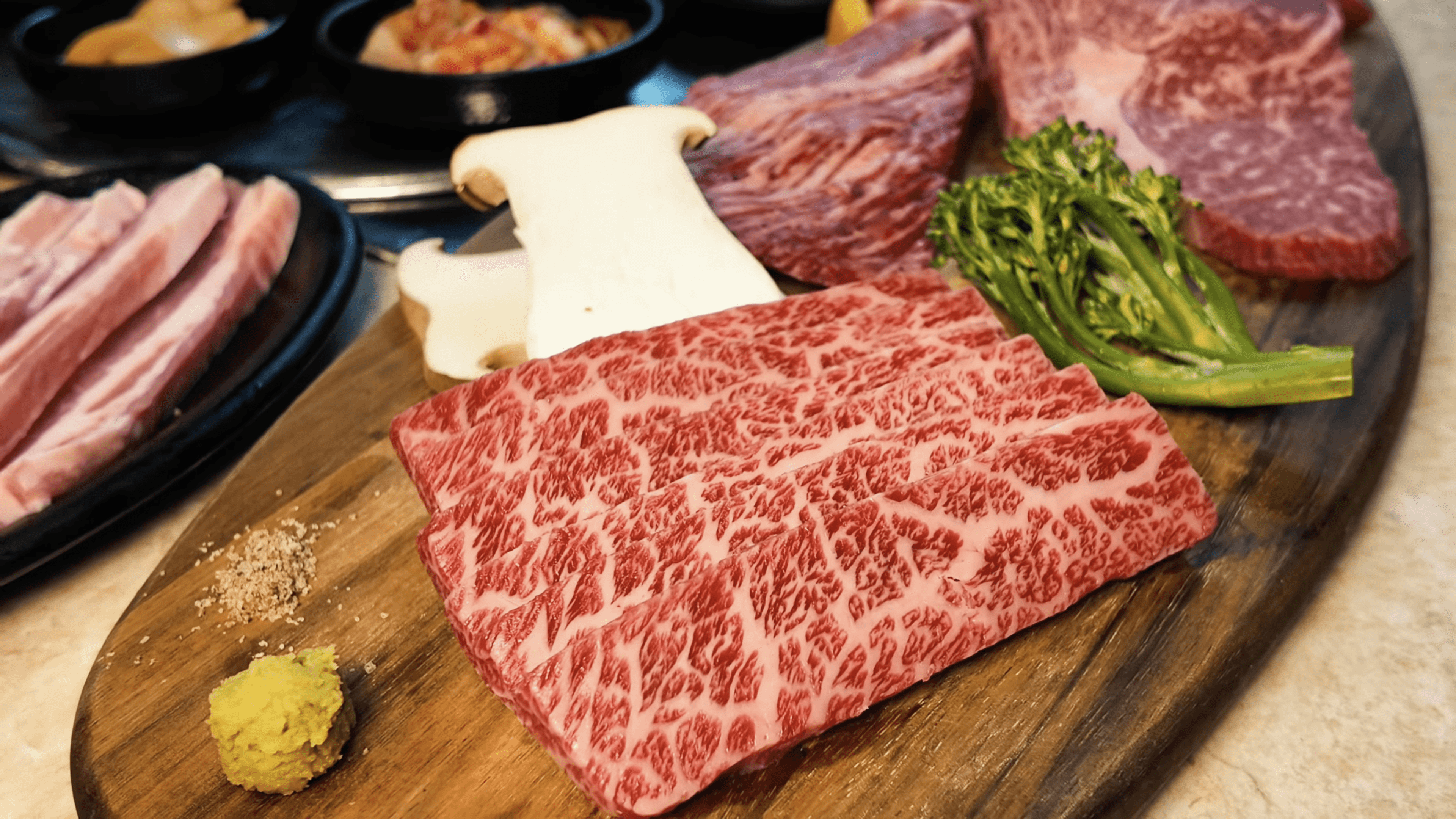 A close-up view of various baked goods on wooden plates, with warm, inviting colors and textures.