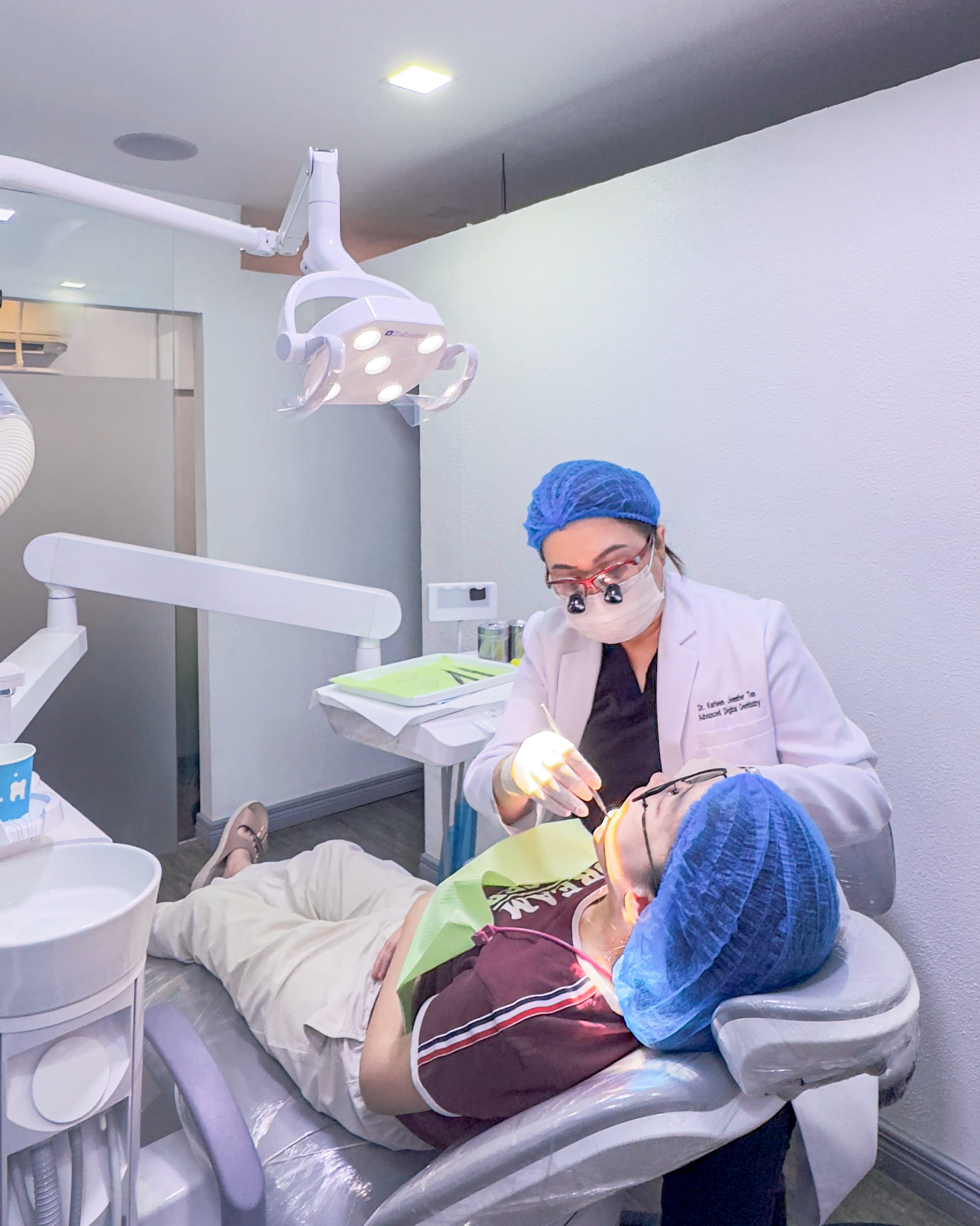 Dentist performing general dentistry treatment including dental check-up and cleaning at K DentArtistry dental clinic in Makati.