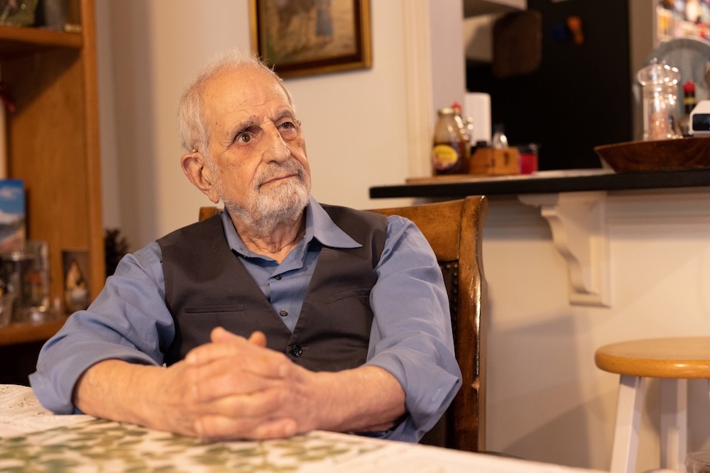 Bubjan with book and speaking to camera