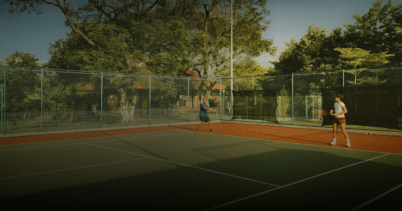 Professional tennis coach Stefan Stankovic teaching a students on a court in Falls Church, Virginia