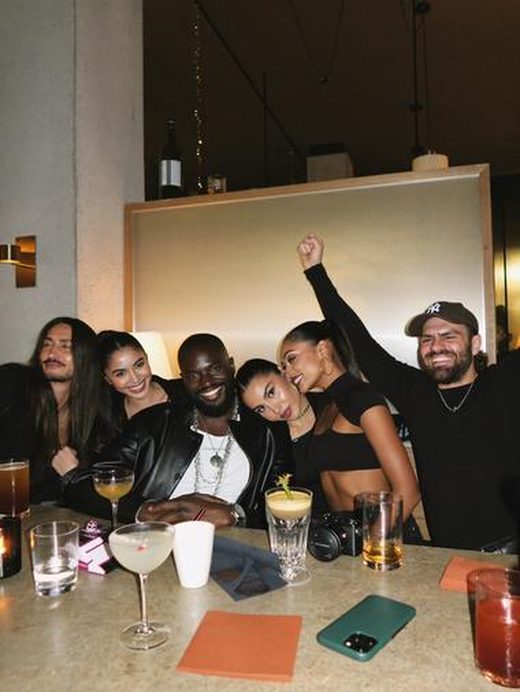 A long table of friends mid-celebration