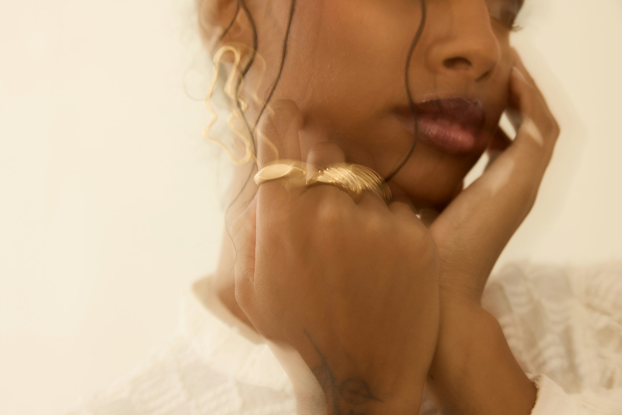 A woman posing behind glass