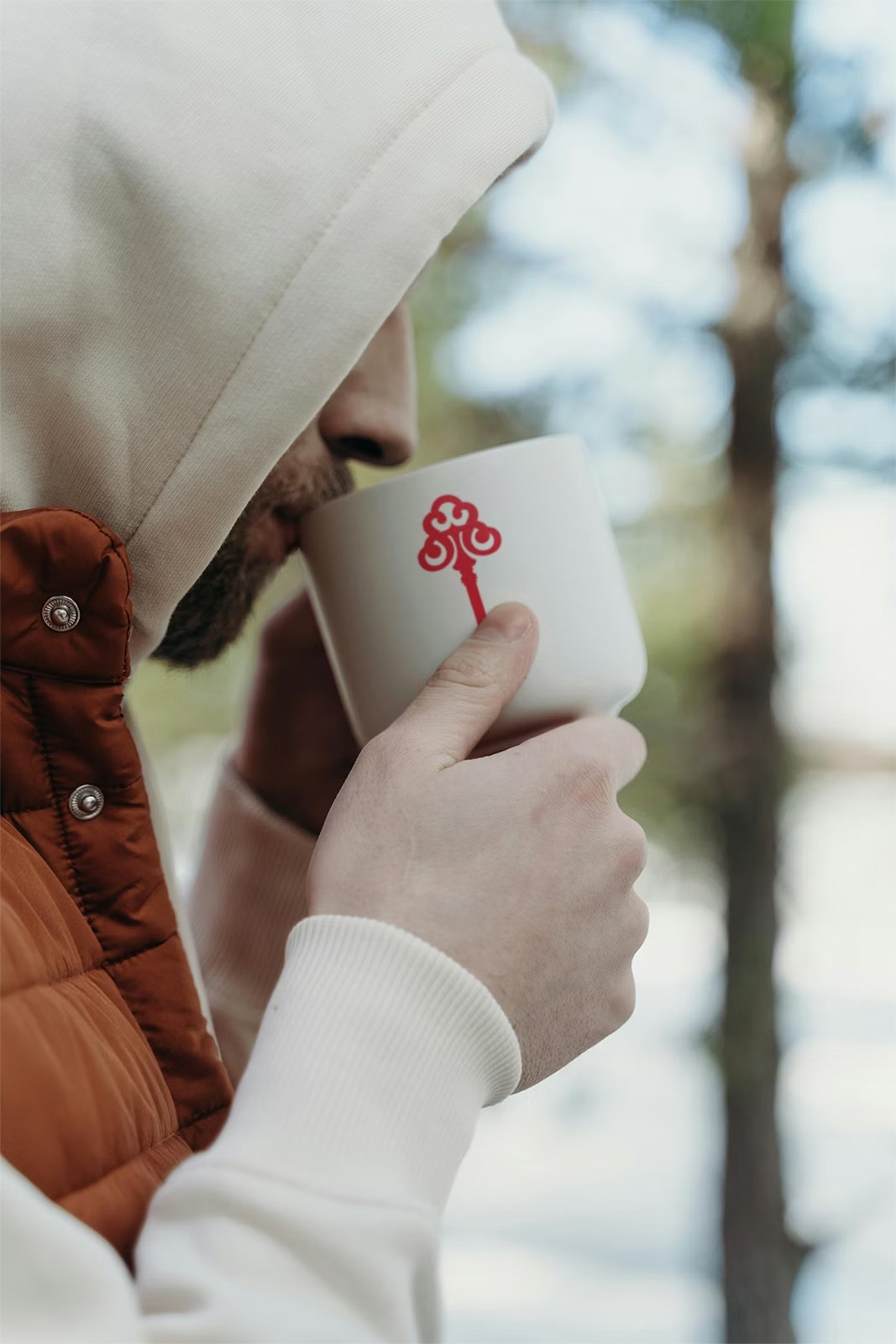 Person drinking out of a STK branded coffee mug