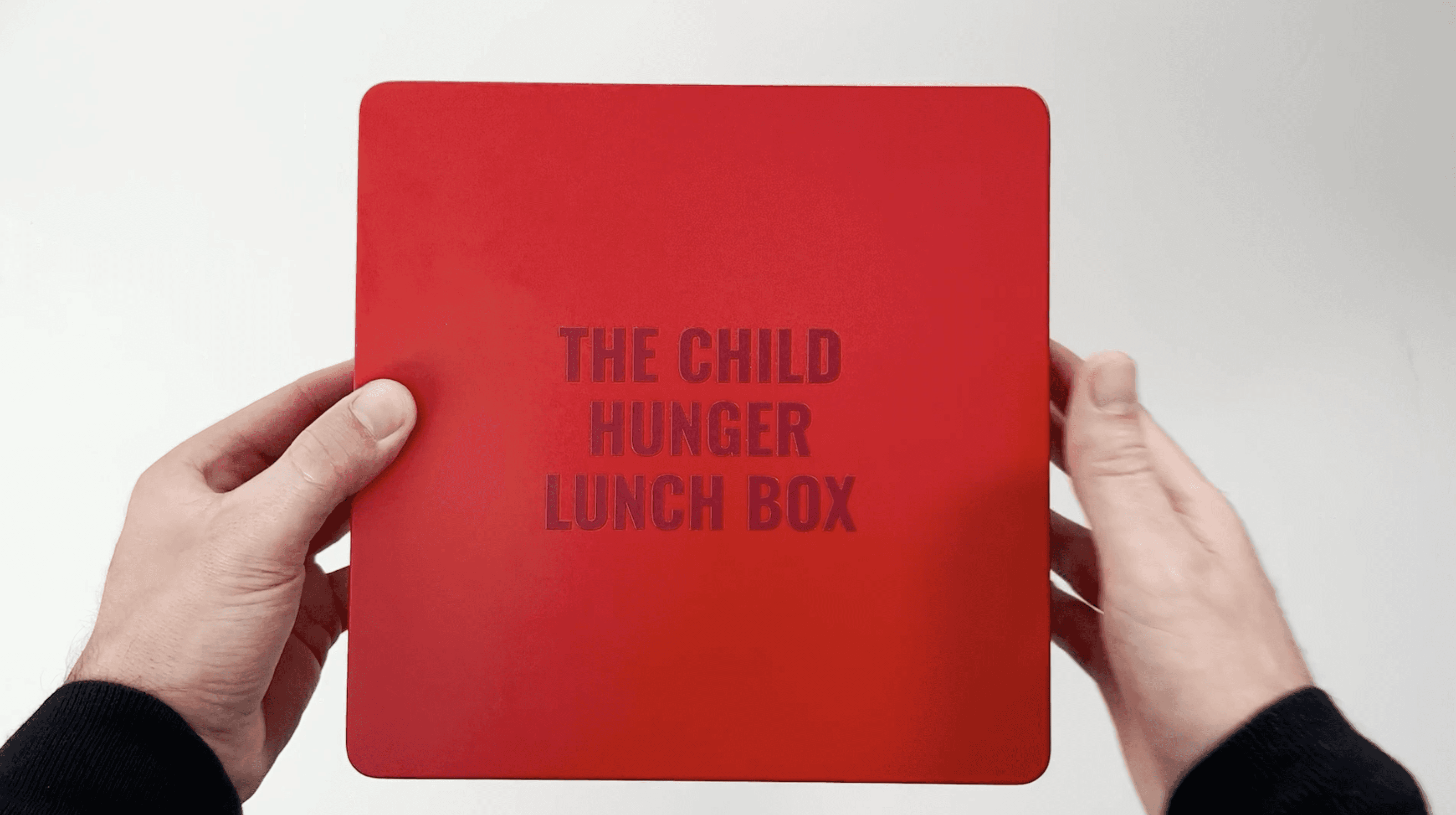 A close-up of a pink cocktail in a martini glass, set against a nighttime background with soft, blurred colors.