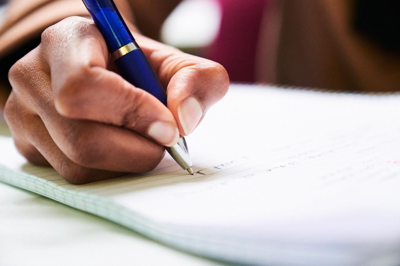 person writing - How To Format A White Paper