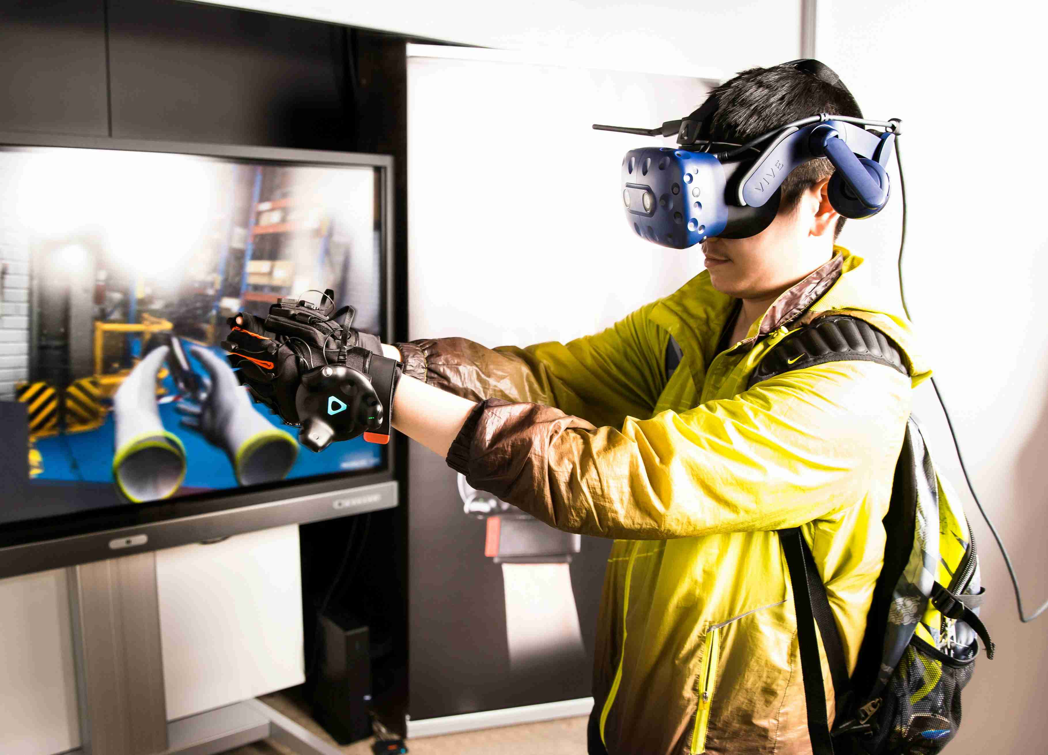 Person using virtual reality headset and gloves for an immersive simulation