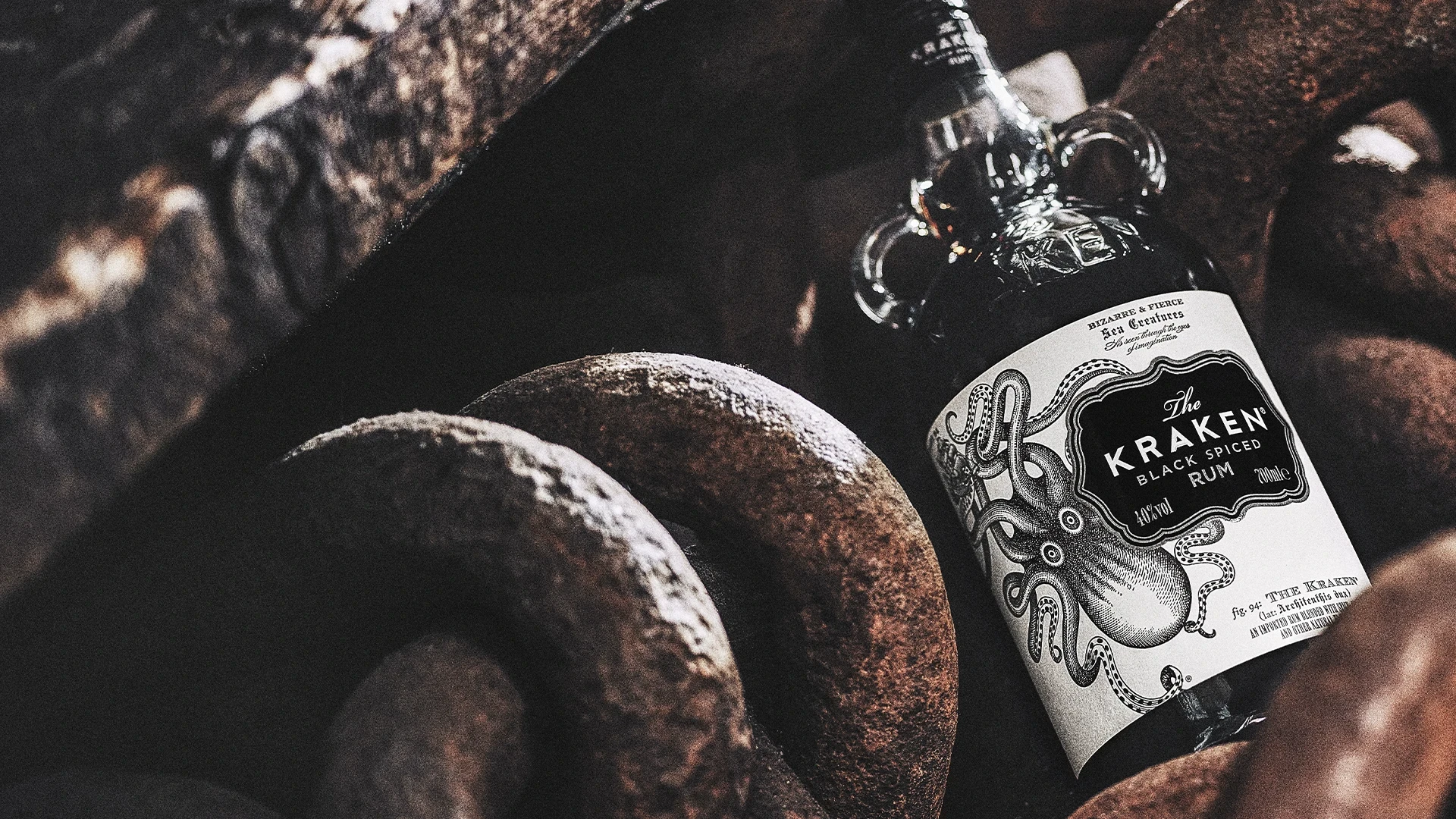 Close up shot of bottle of Kraken Rum on a weathered ship