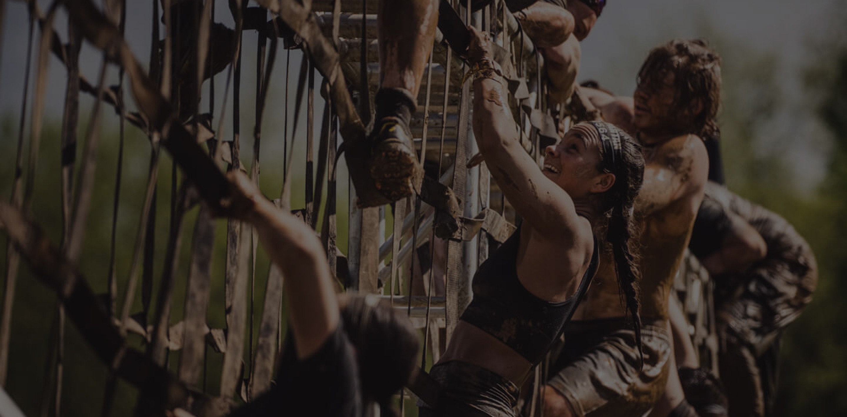 Background image of people climbing a cargo net at a Spartan Race