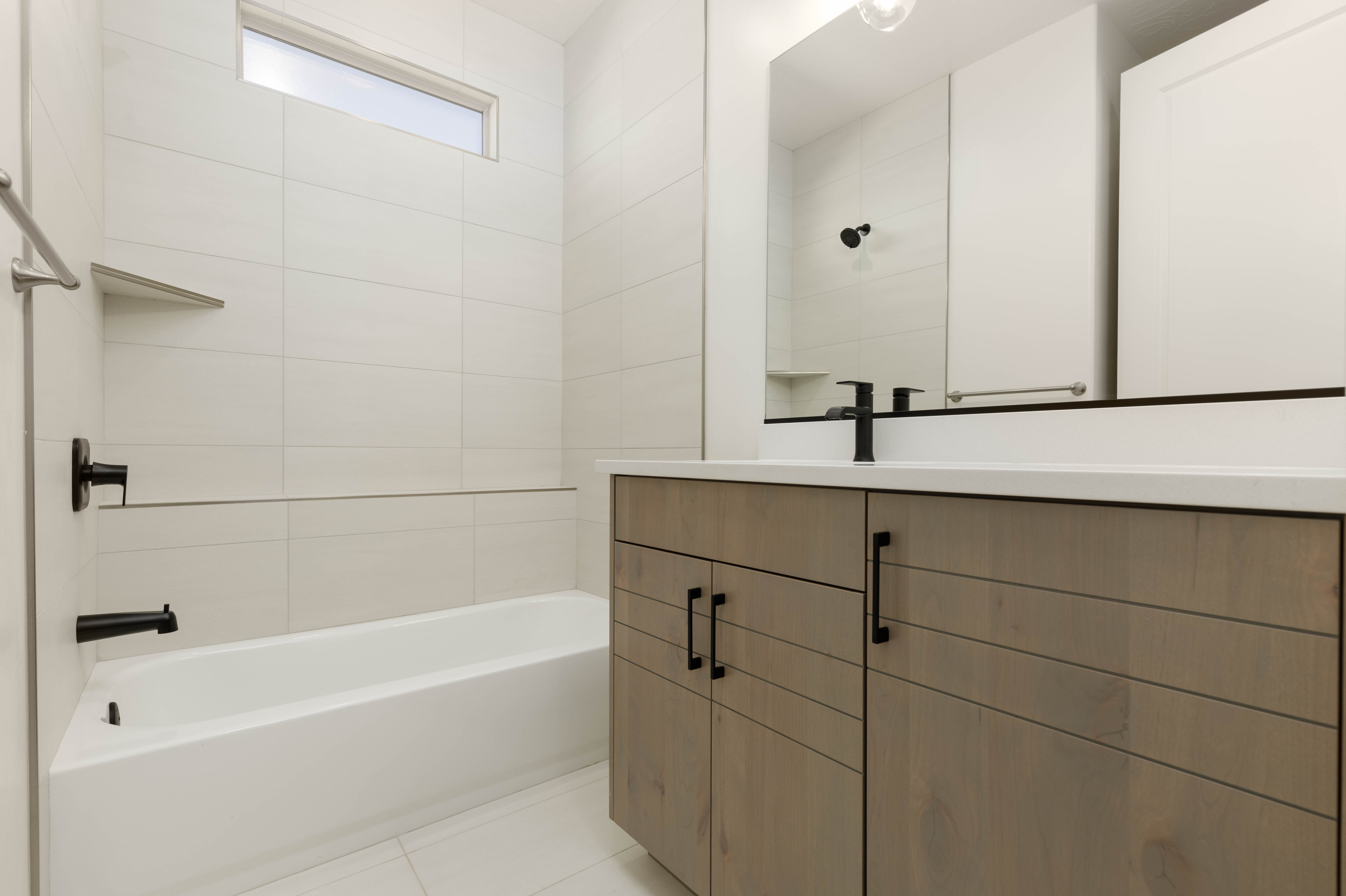 Bathroom featuring bathtub with tiled shower walls in The Meridian home in Hurricane Utah.