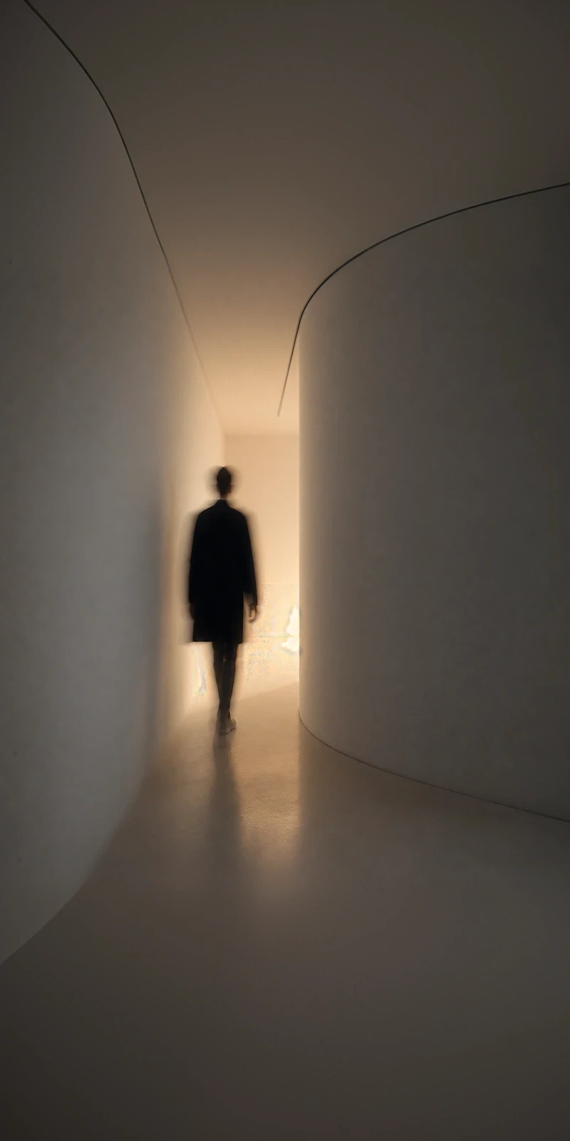 Minimal architectural corridor with lone silhouette — representing purposeful direction and clarity in the UI/UX design process