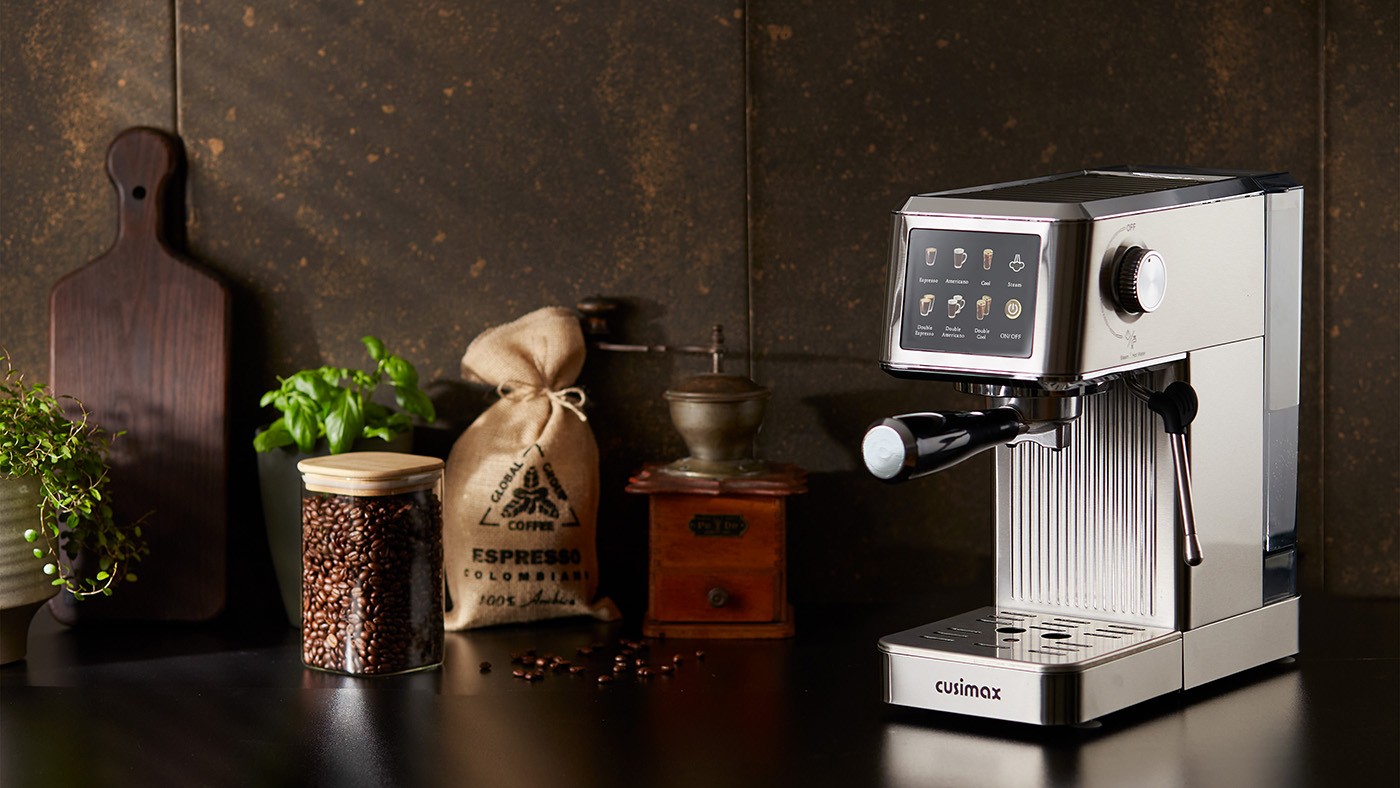 A modern espresso machine with a digital touchscreen is displayed on a dark kitchen counter, surrounded by a wooden cutting board, a small plant, a jar of coffee beans, a burlap sack labeled "ESPRESSO," and a vintage coffee grinder, creating a cozy and inviting coffee-making setup.