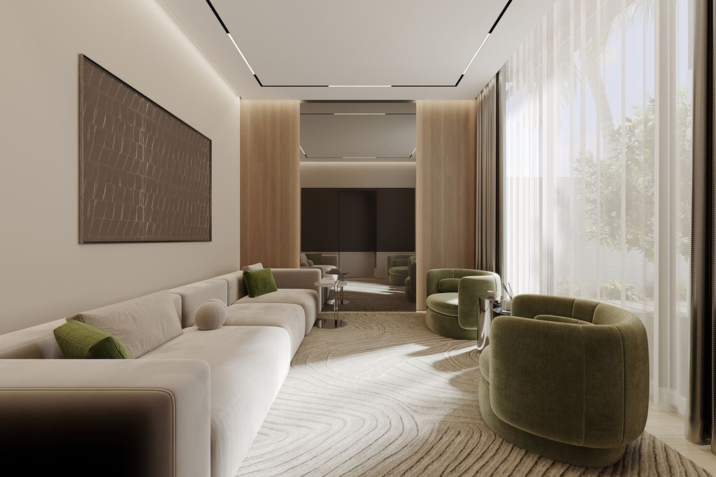 A modern living room featuring green chairs and a large window, showcasing the stylish design of Lua Residences.
