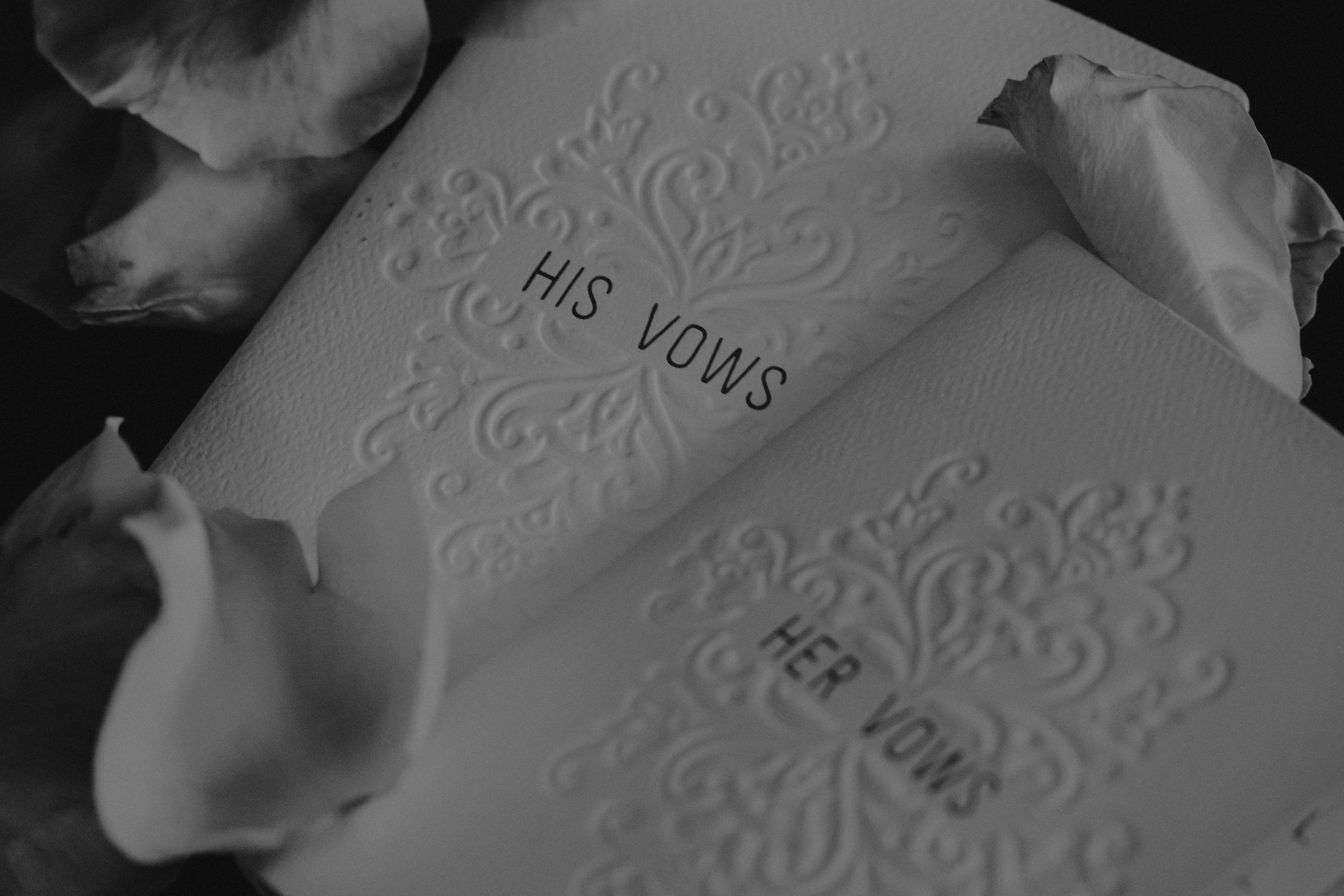 two notebooks that read 'his vows' & 'her vows' on them