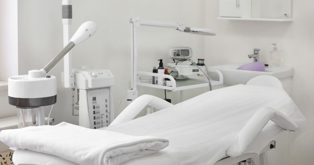 Laser cosmetic clinic room with treatment bed and equipment