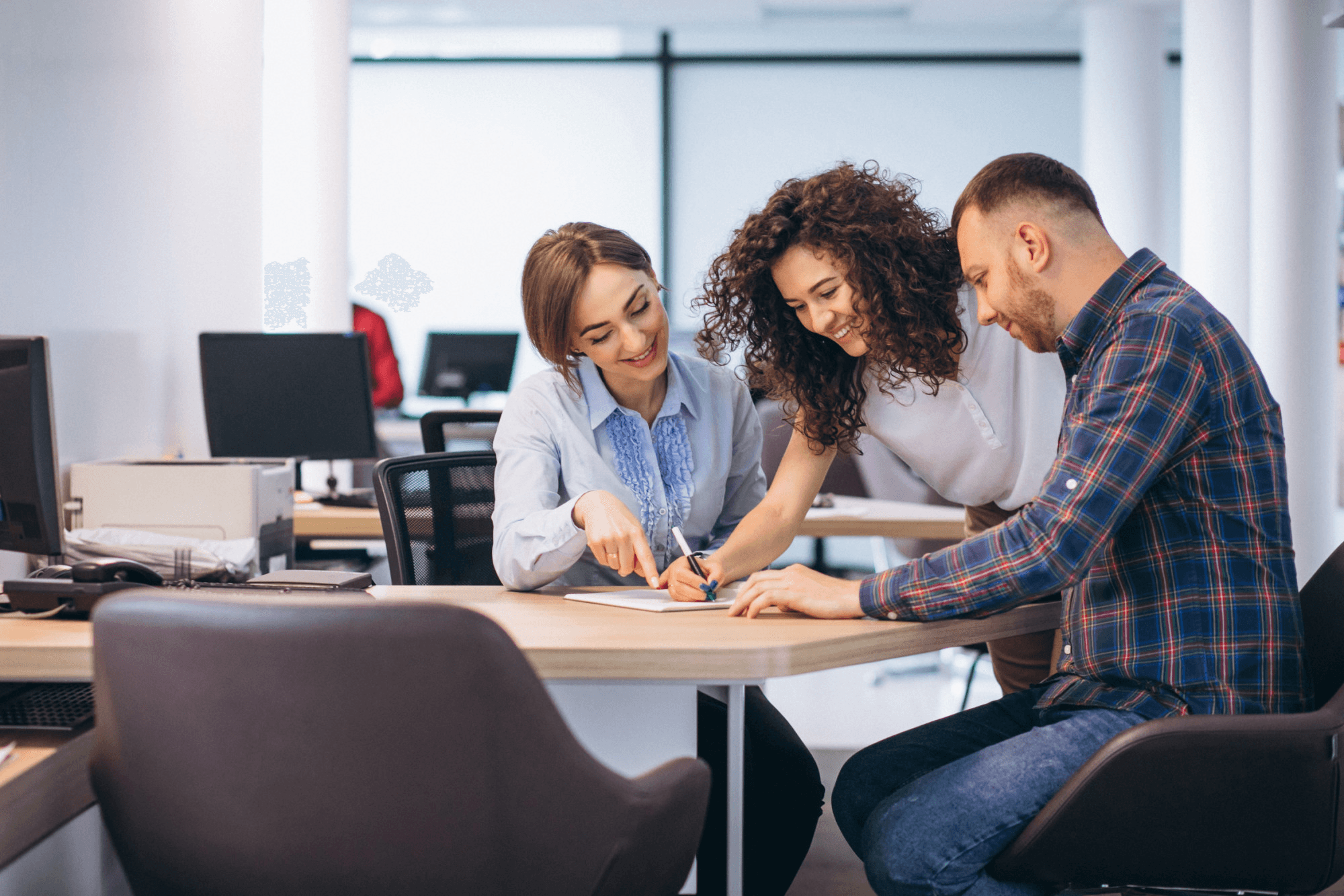 Colleagues talking at desk