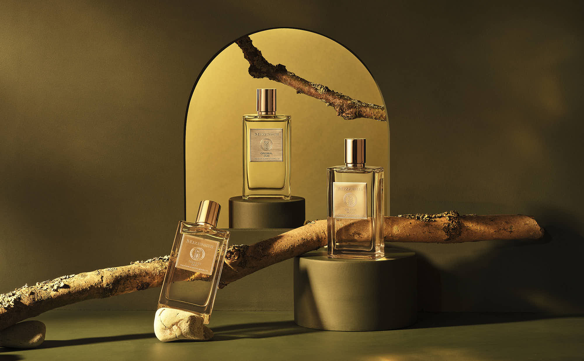 An artistic arrangement of wooden sticks, bottles, and a smooth stone set against a softly lit background.