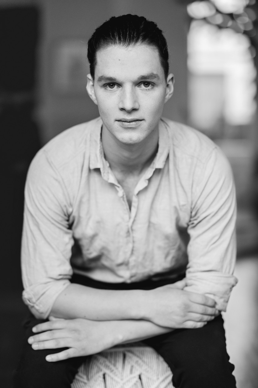 Smiling person seated indoors — founder of Seven Life Areas, offering guidance for living with clarity, harmony, and purpose.