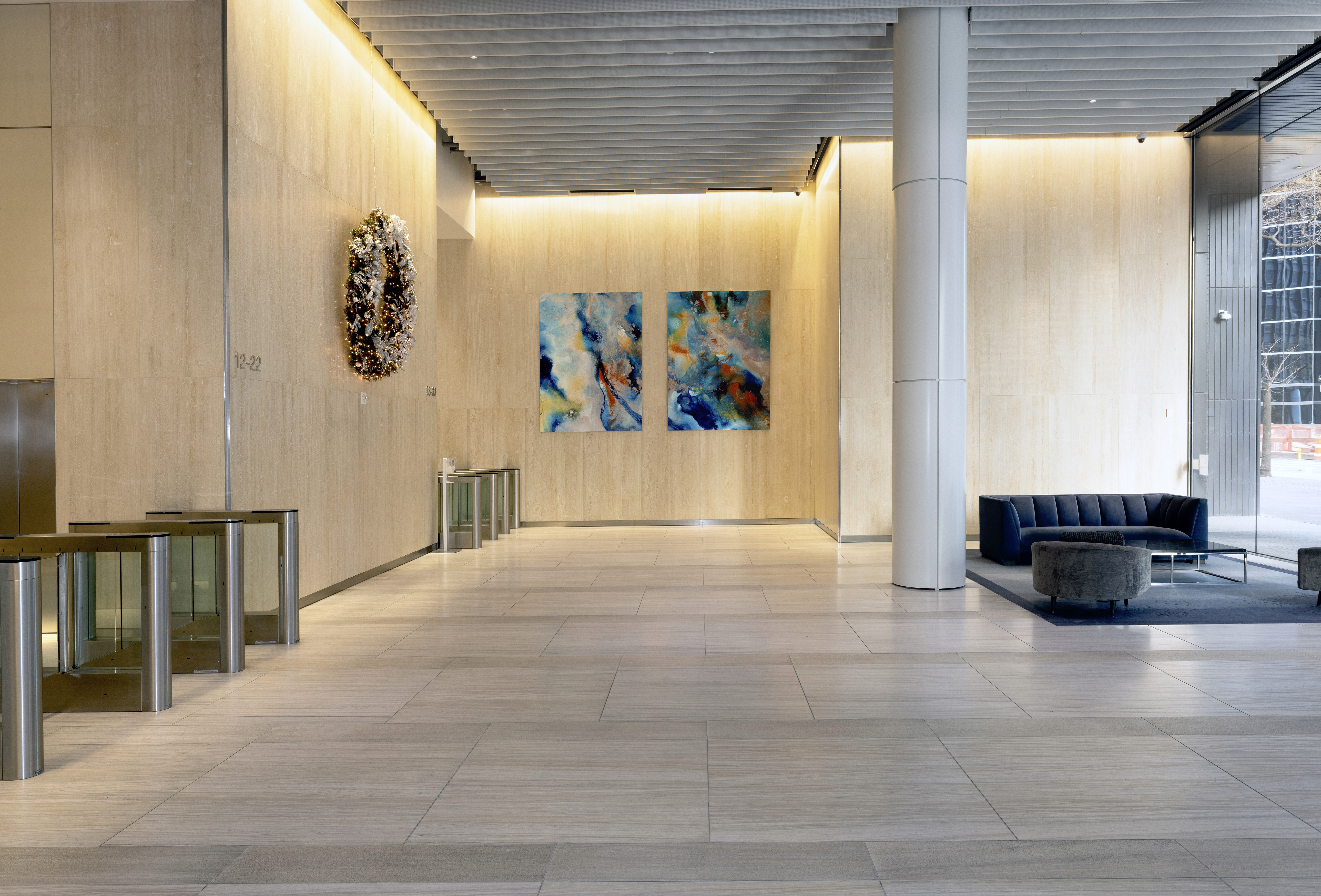 A woman observes framed black-and-white photographs in warm golden light