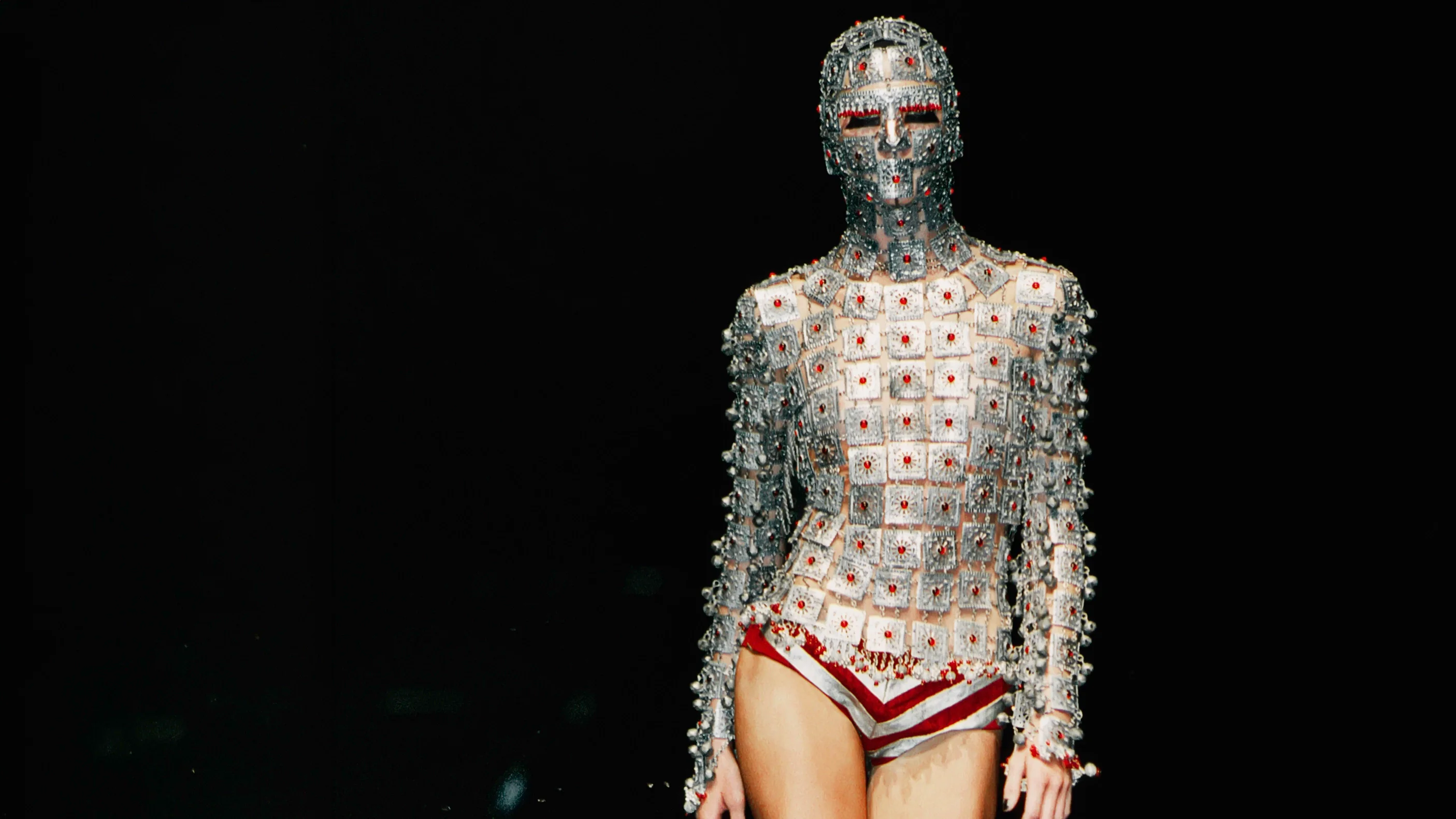 Close-up of a runway model wearing the iconic chainmail yashmak face and body veil crafted by jeweller Shaun Leane for an Alexander McQueen couture collection.