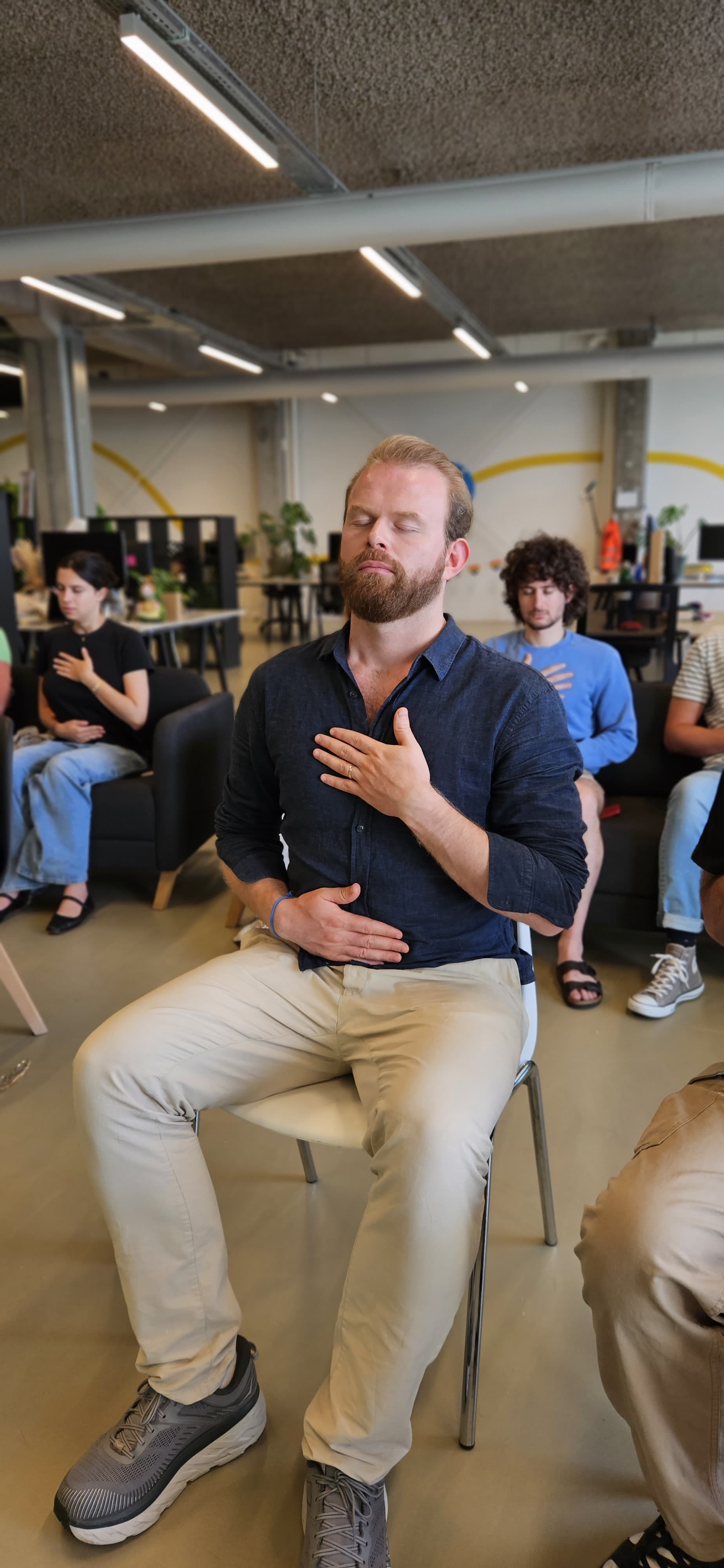 Network switches with glowing lights beside a laptop in a clean tech setup.