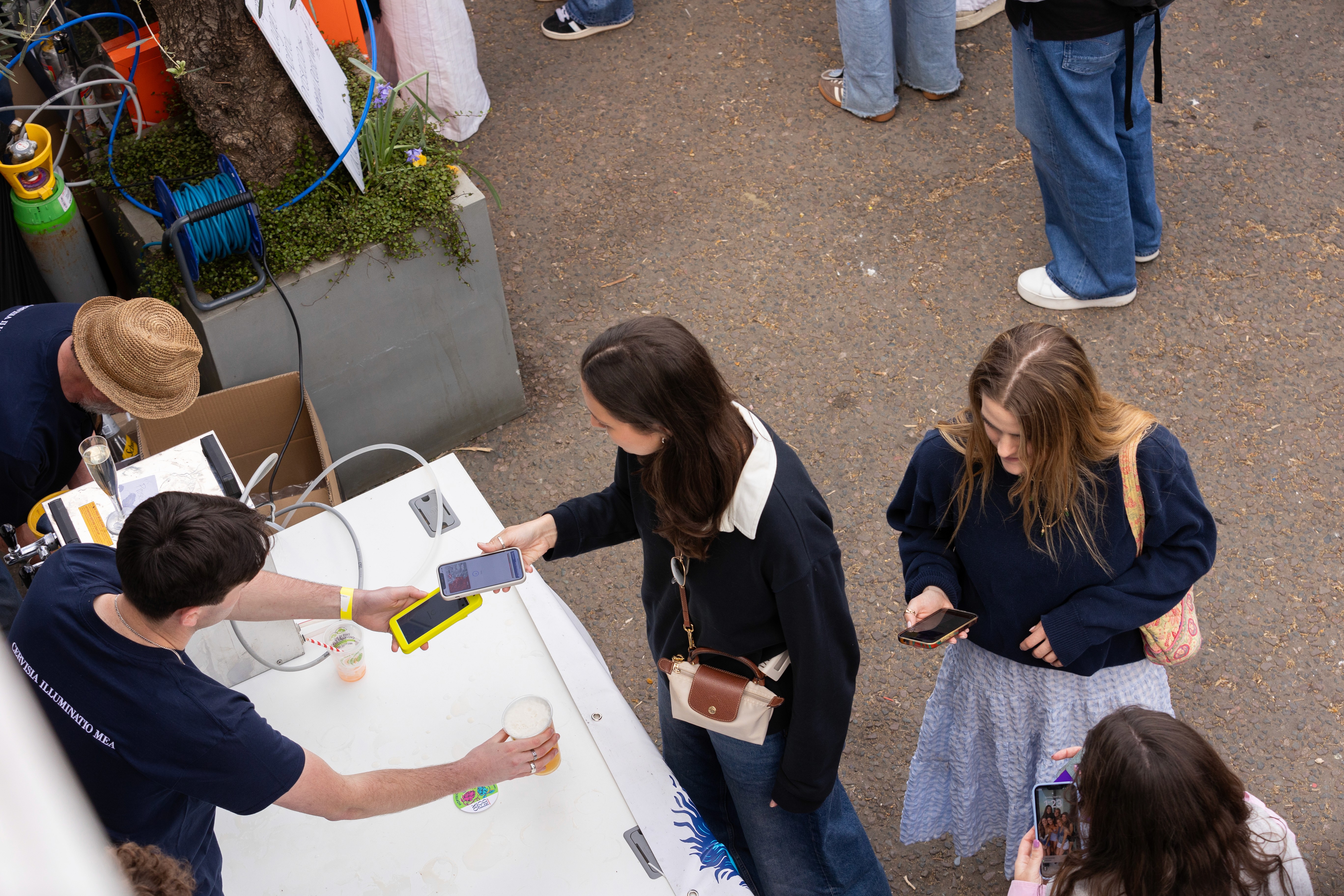 Last customers of a busy day paying with phone tap
