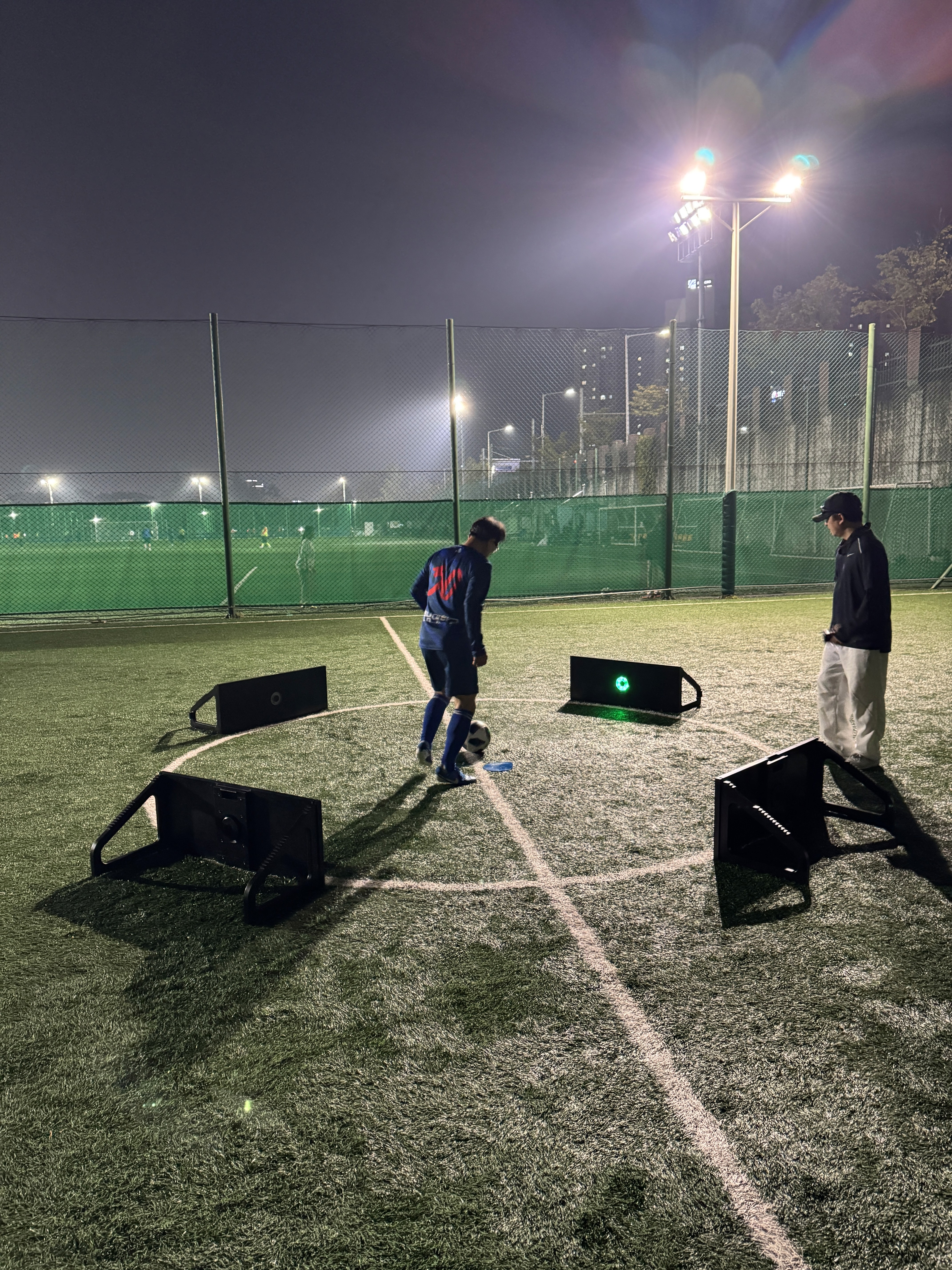 a person's feet with a ball on a purple carpet