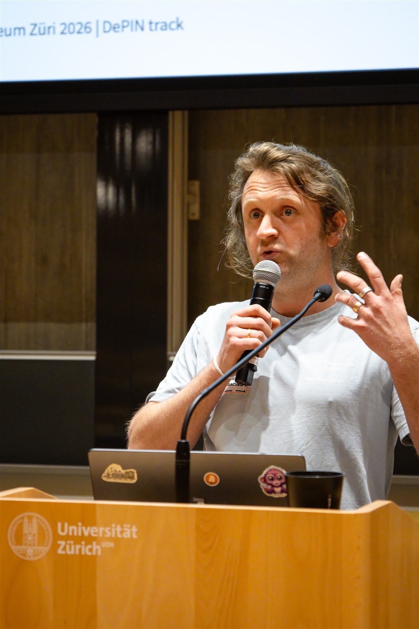 Speaker explaining blockchain concept during EthereumZüri conference