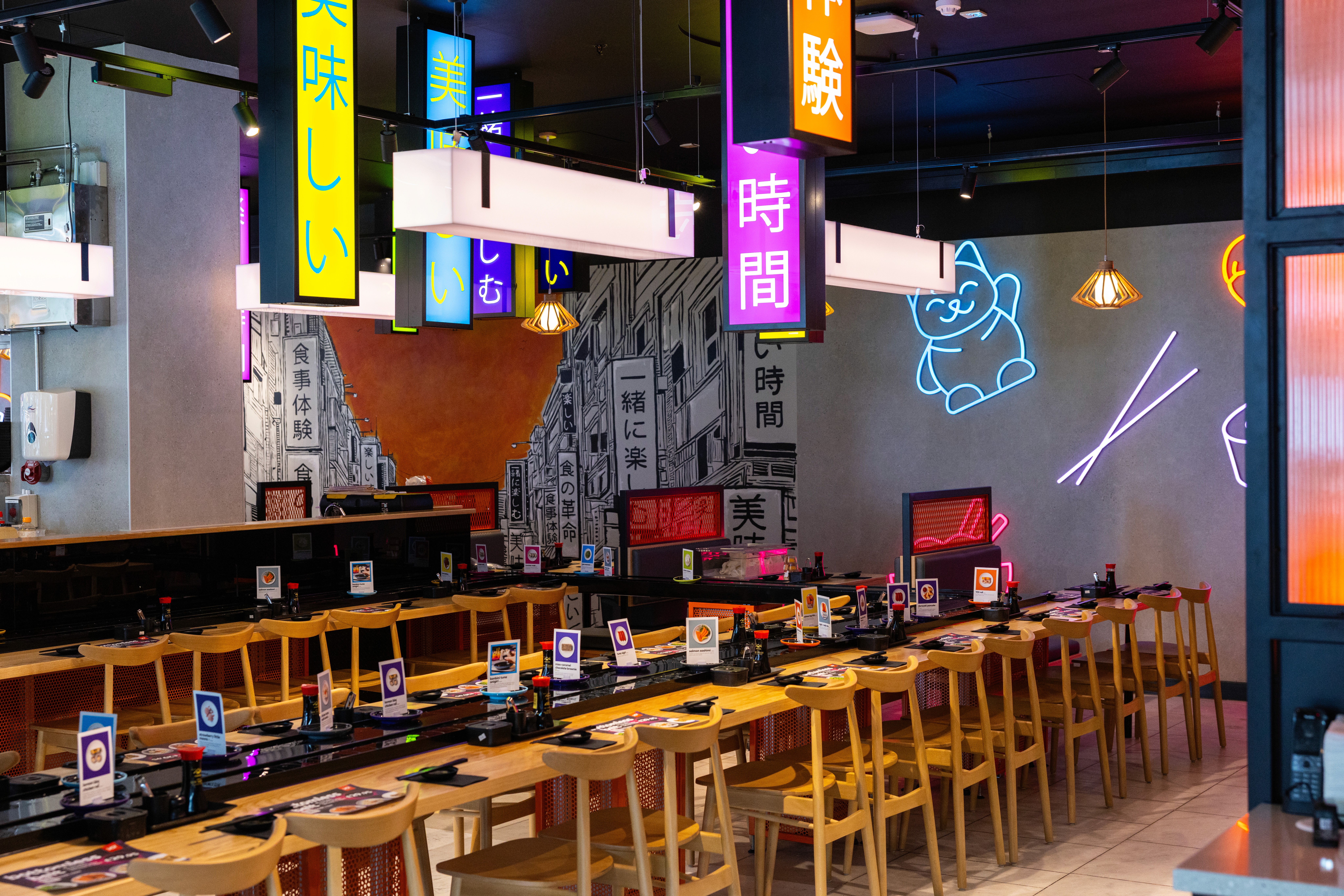 Restaurant shopfitting with bespoke counters, branded feature lighting and commercial fit-out finishes for YO! Sushi