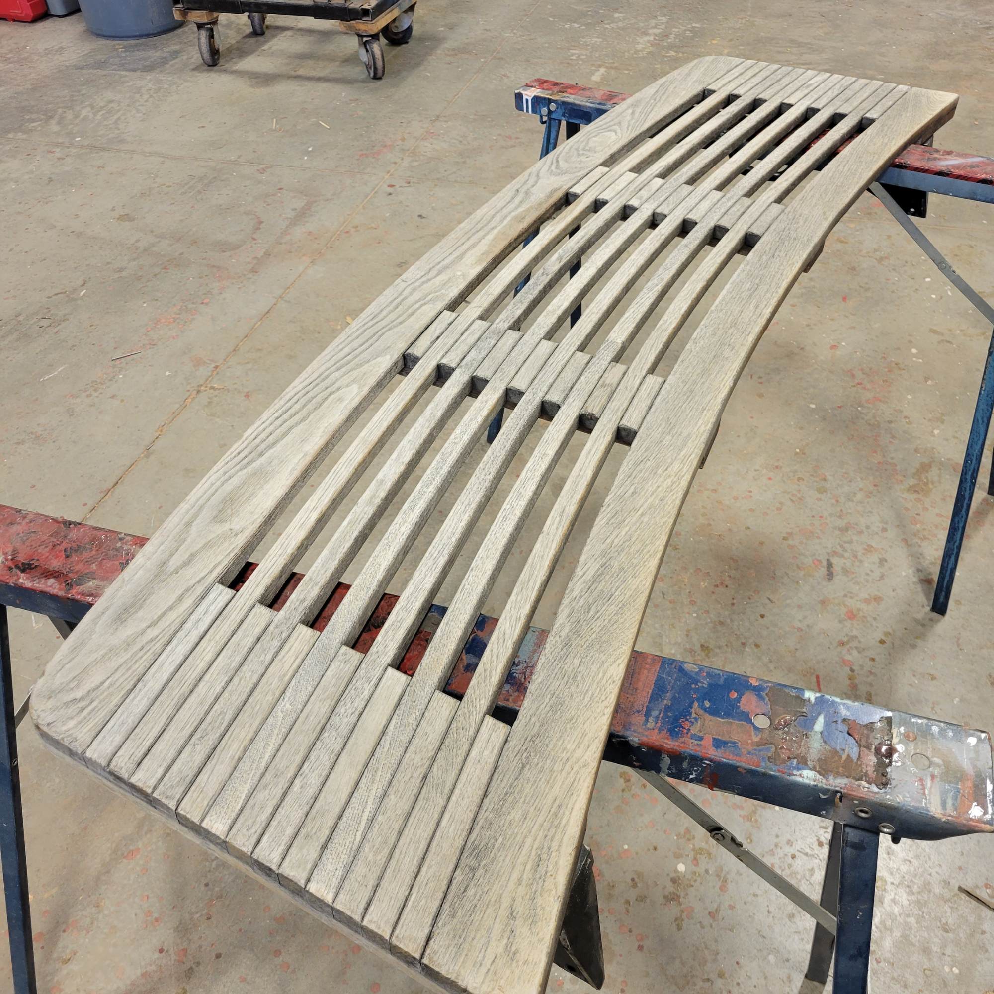 Swim platform on a boat that is made of teak and has been sanded down to be refinished and renewed