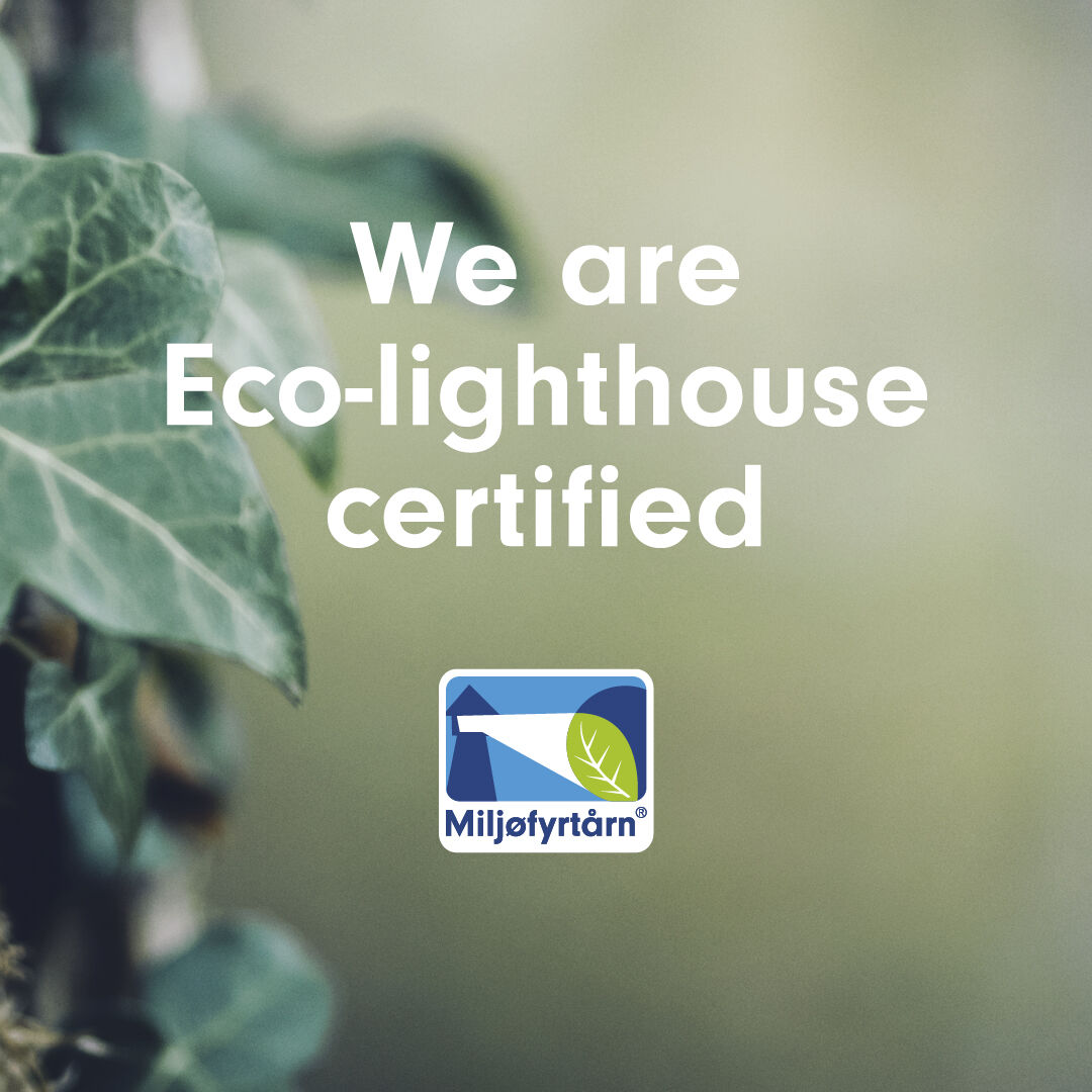 Smiling woman in front of ECO-lighthouse miljøfyrtån certification 