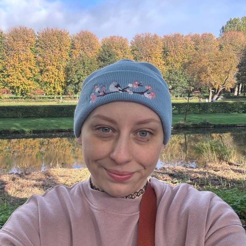 smiling woman wearing blue necklace