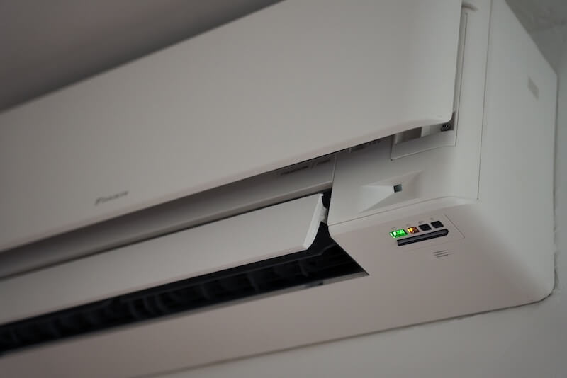 Woman standing in the entrance of her home.