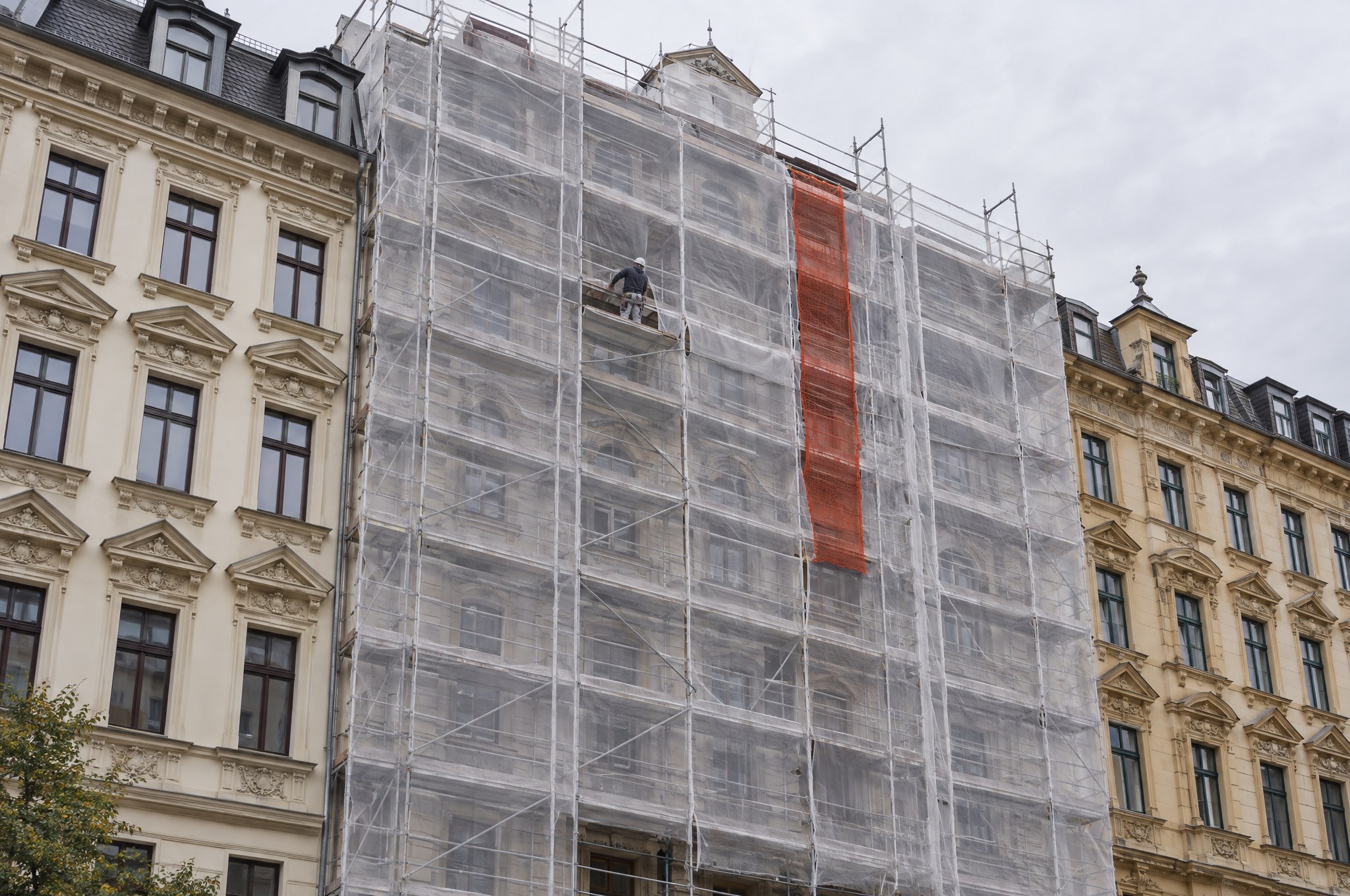 Gründerzeit facade in Leipzig wrapped in scaffolding while it is being rebuilt
