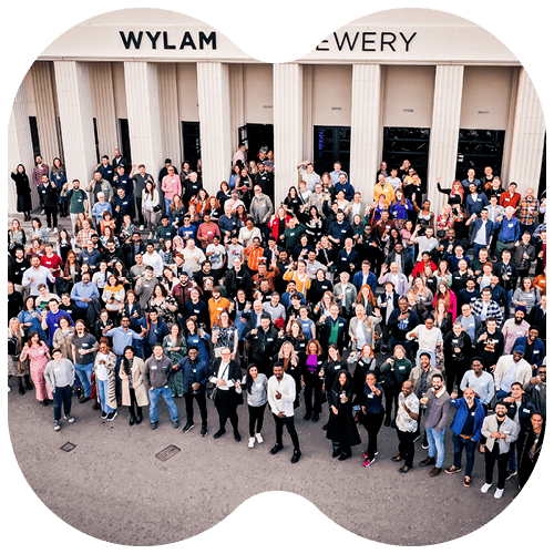 Drone shot of Opencast people standing on the steps of Wylam Brewery after a conference