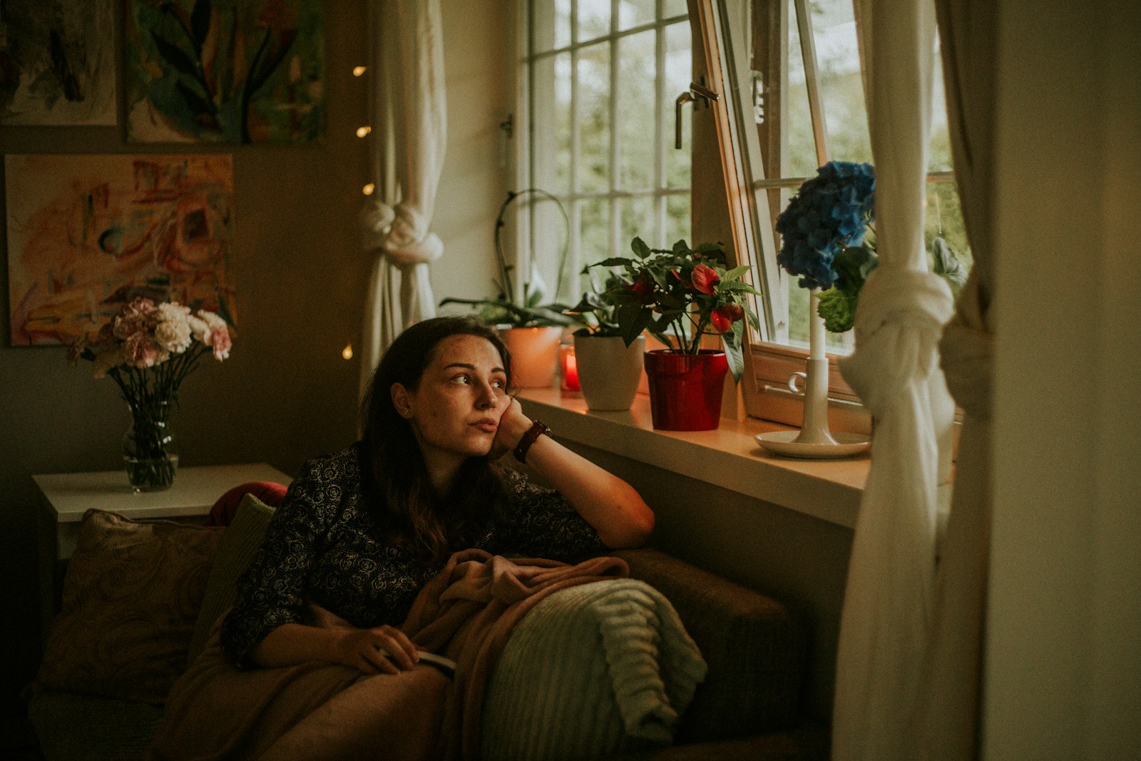Person resting beside a window after the day