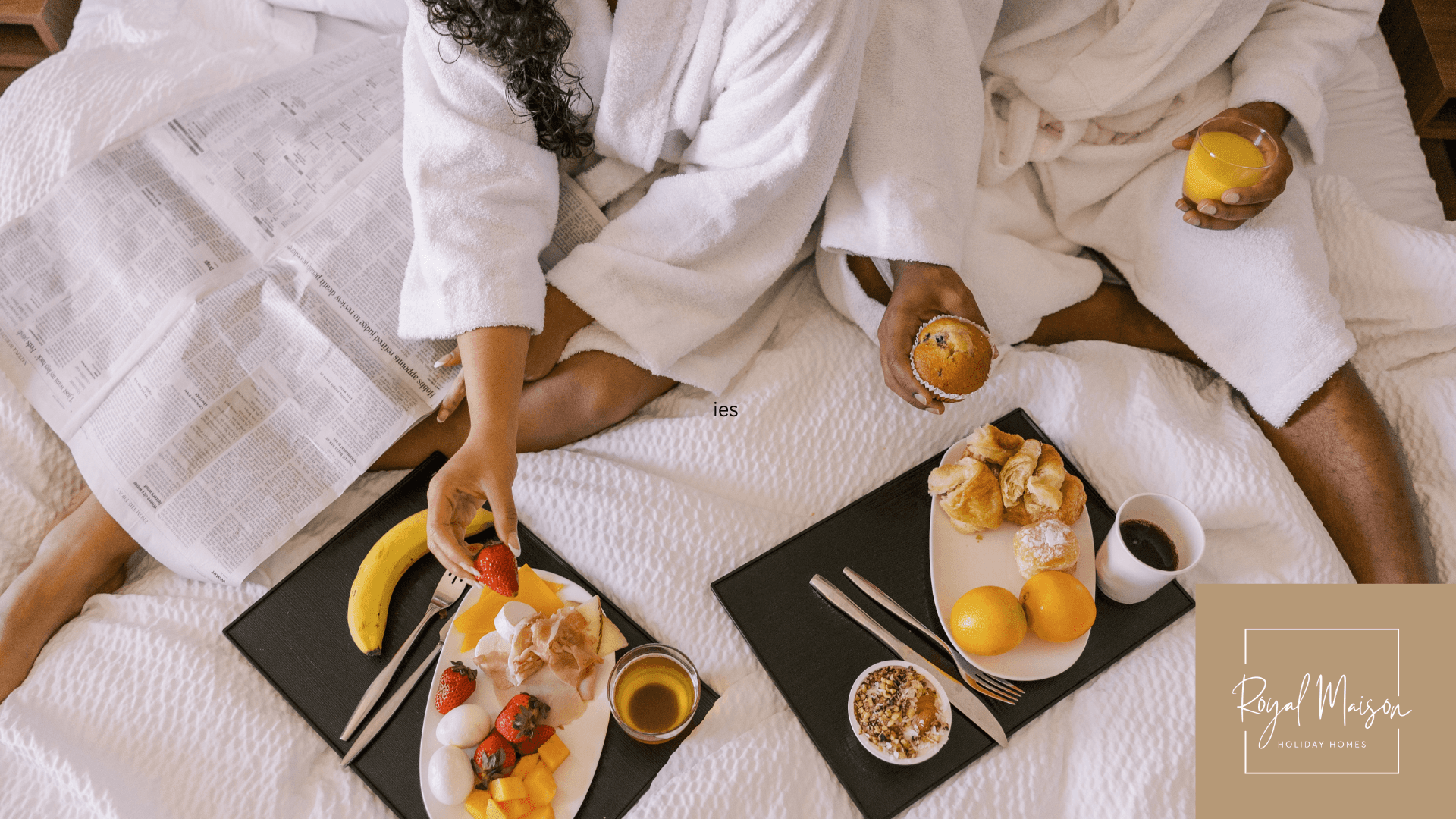 couple eating on bed in hotel room