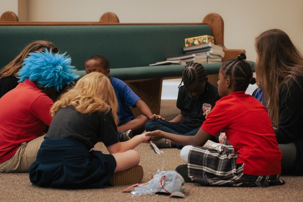 Elementary class in a prayer circle, during a school prayer meeting