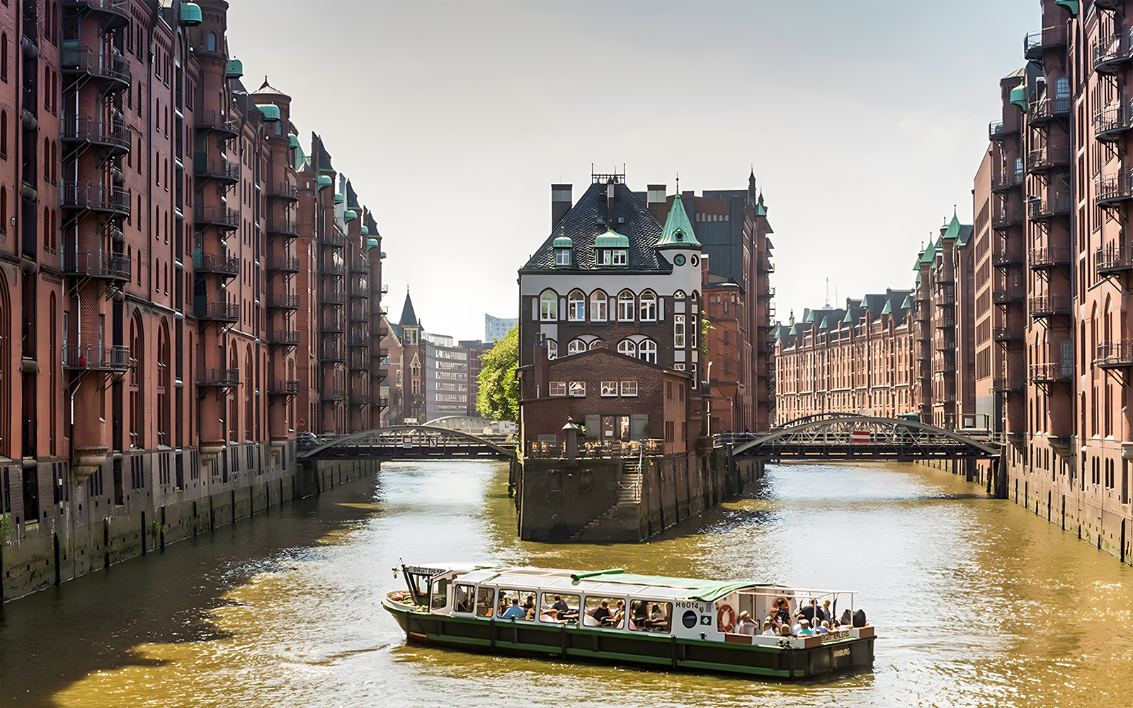 Boat tour through Hamburg's Speicherstadt with historic brick warehouses.