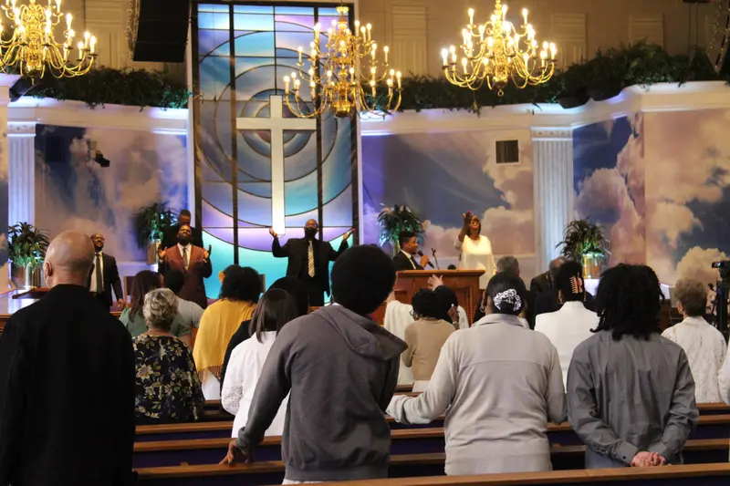 Congregation worshipping during a Peace Apostolic Church service