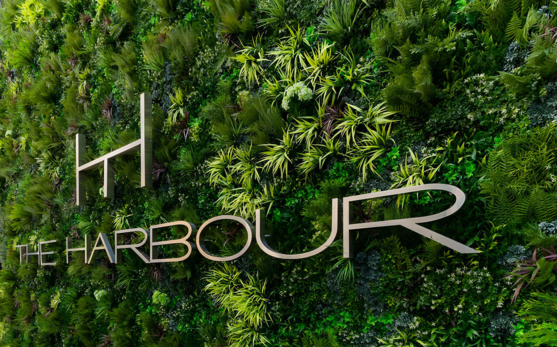 The Harbour Hotel's modern typographic font appears to grow from the life-like VistaFolia Artificial Green Wall.