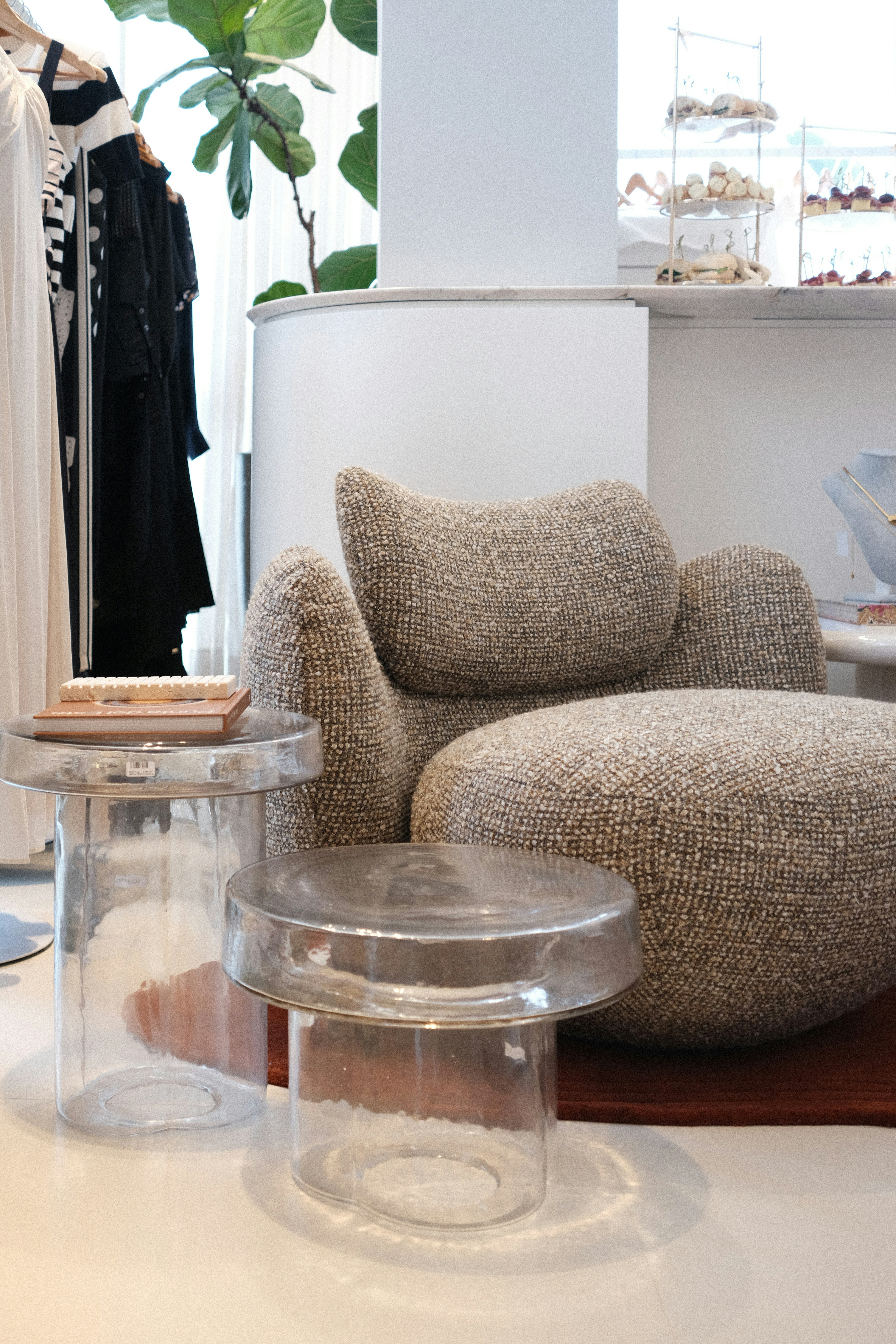 Plush armchair with clear glass side tables