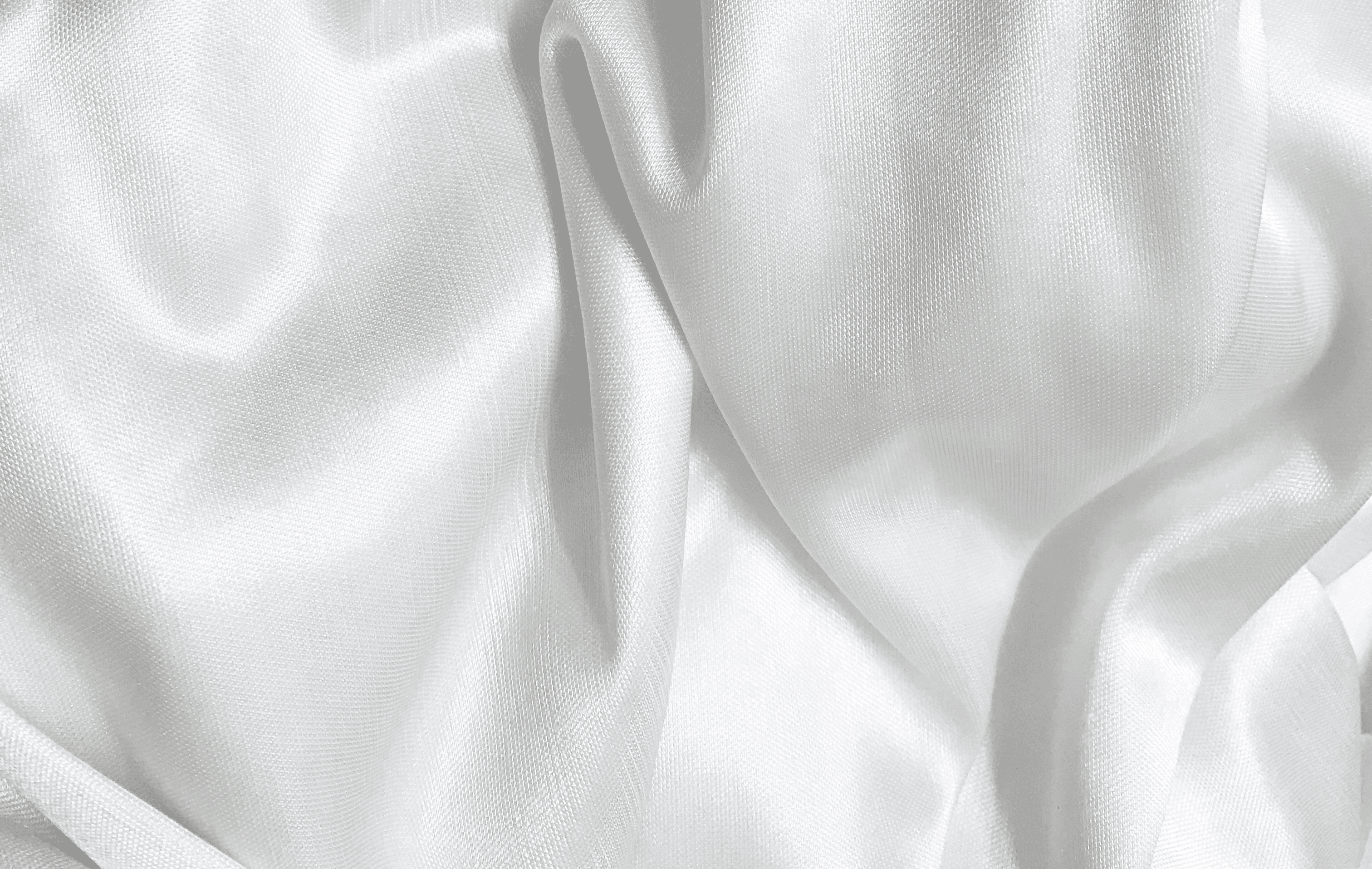 white textile on brown wooden table