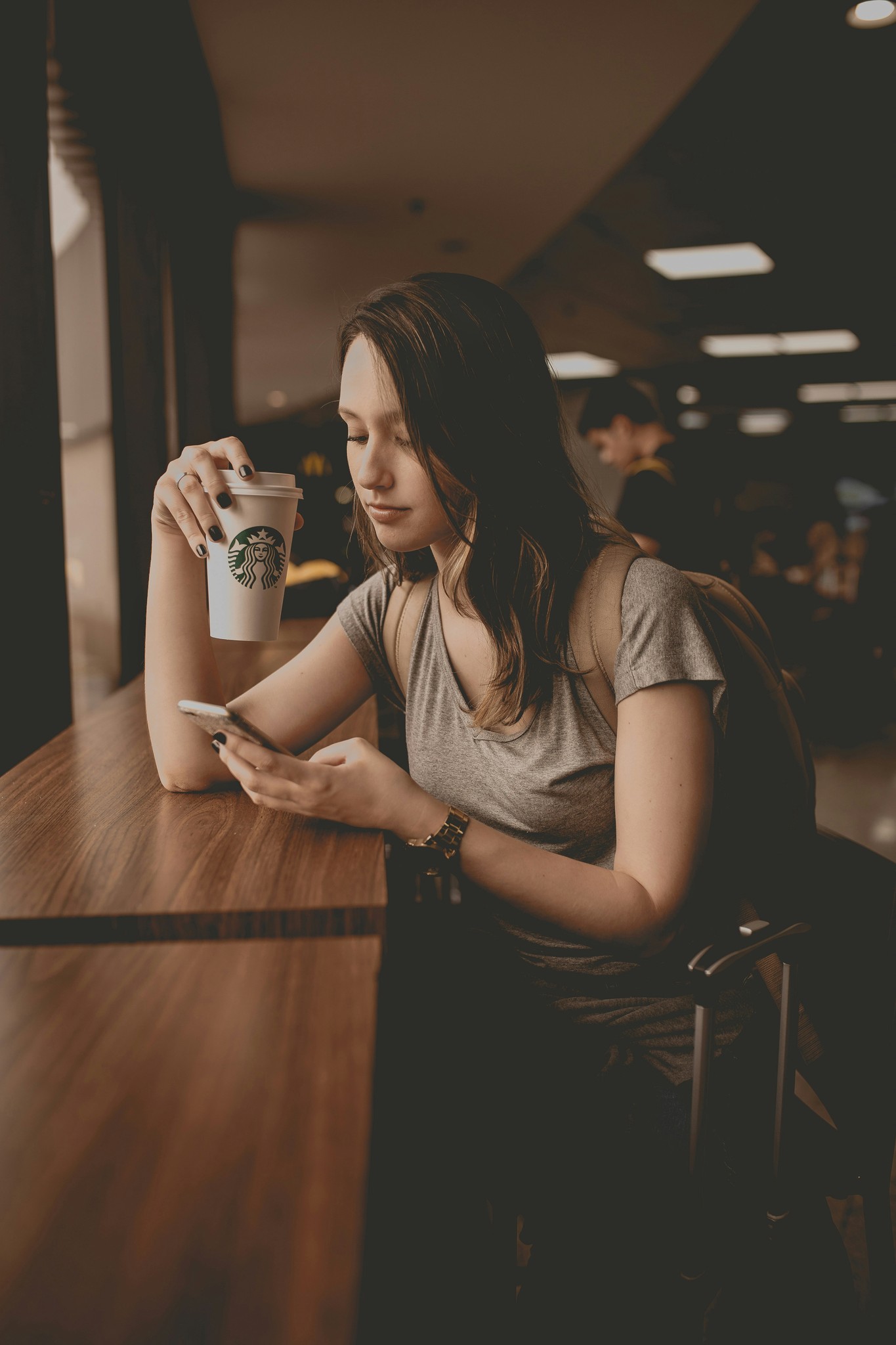 Barista pouring frothed milk into coffee cup